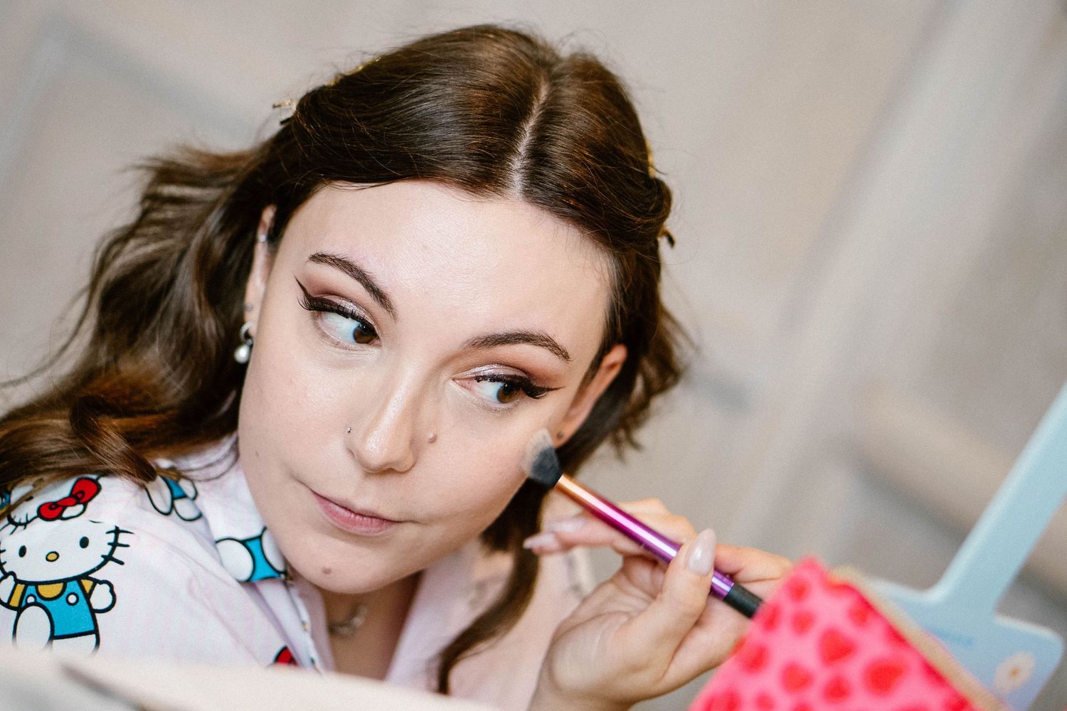 Getting ready moments during wedding preparations with makeup and styling details.