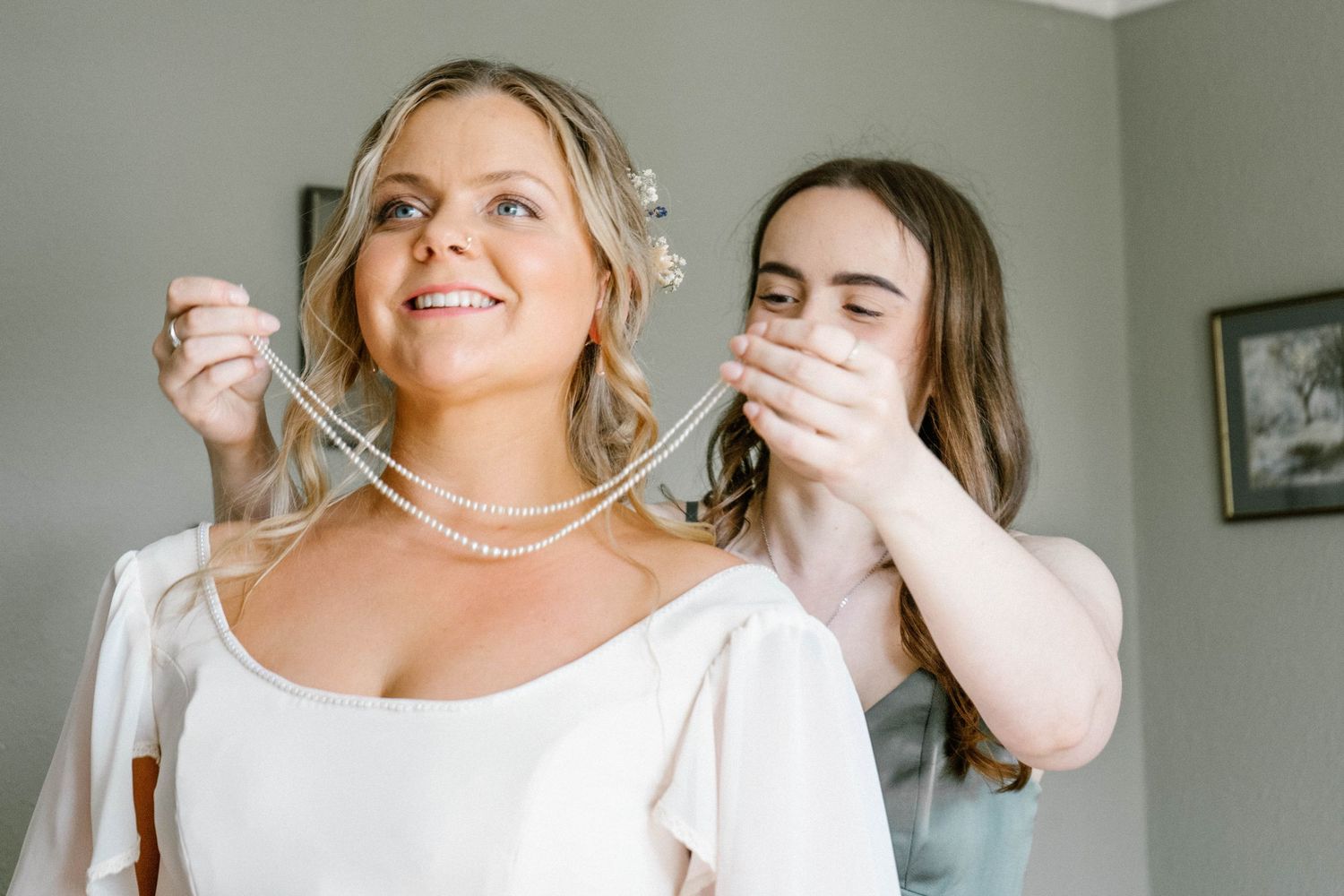 Joyful wedding preparation moments in a bright indoor setting.
