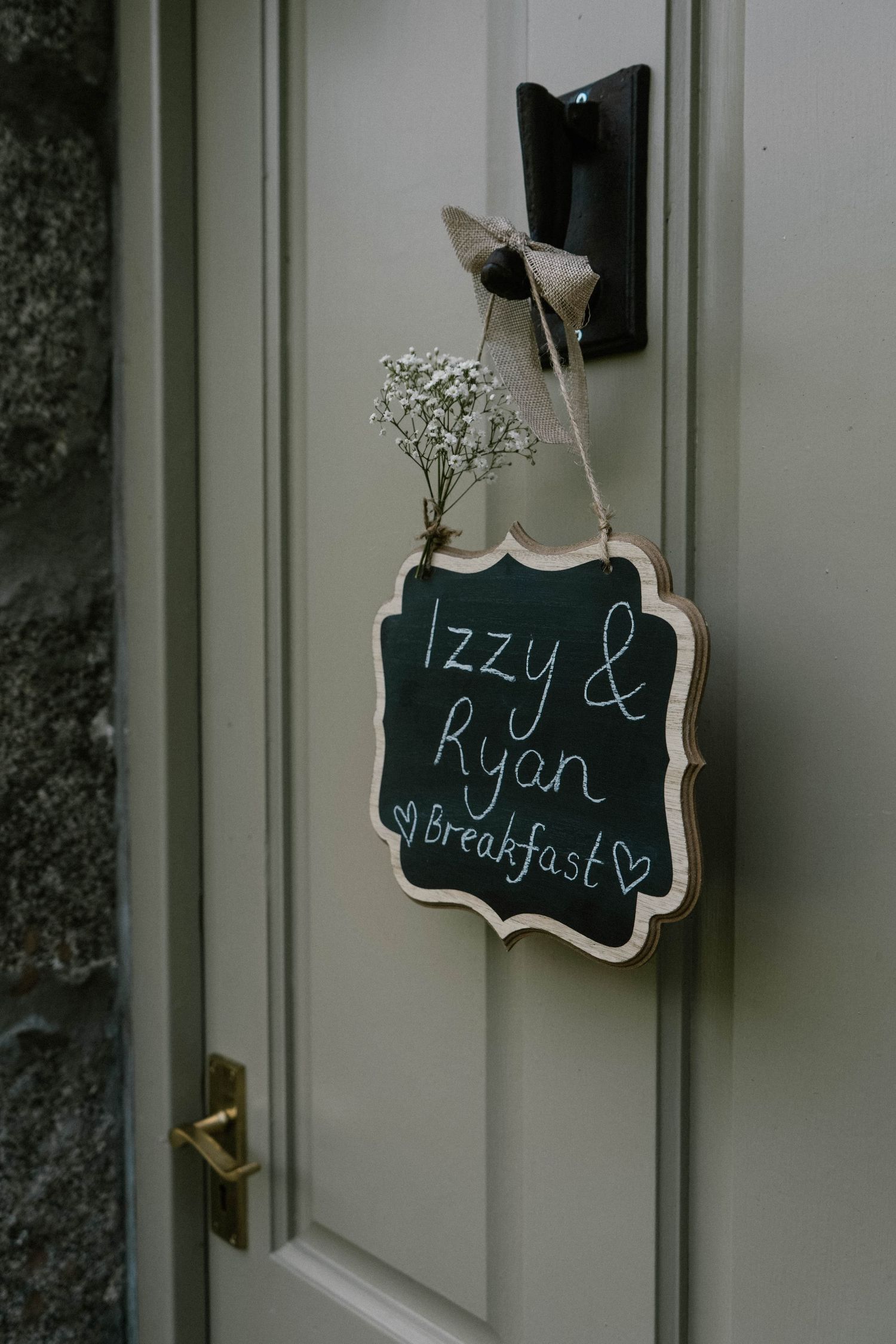 Small decorative chalkboard signs with handwritten text displayed on a door.