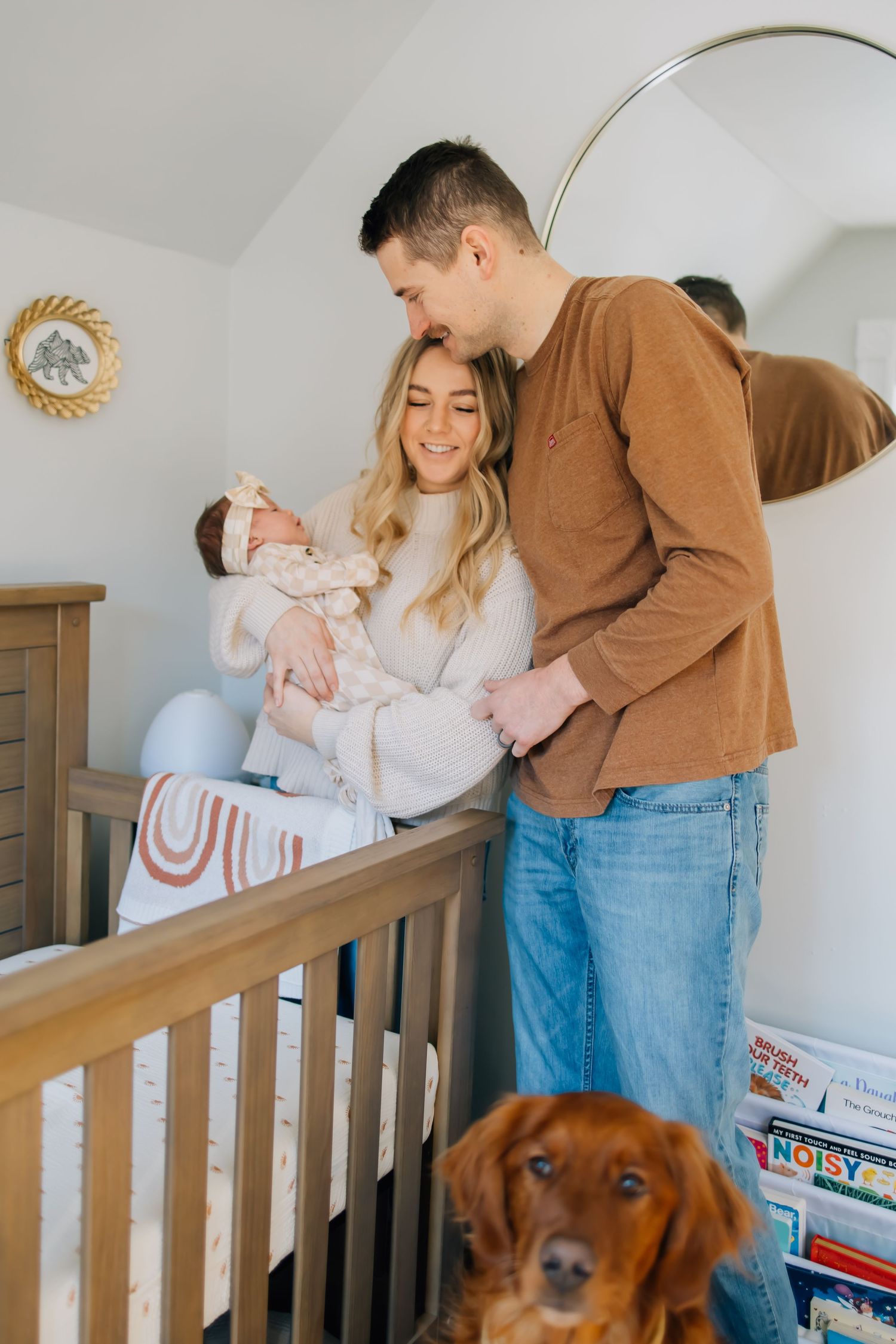 Lifestyle newborn photography of a small family in their infant's nursery