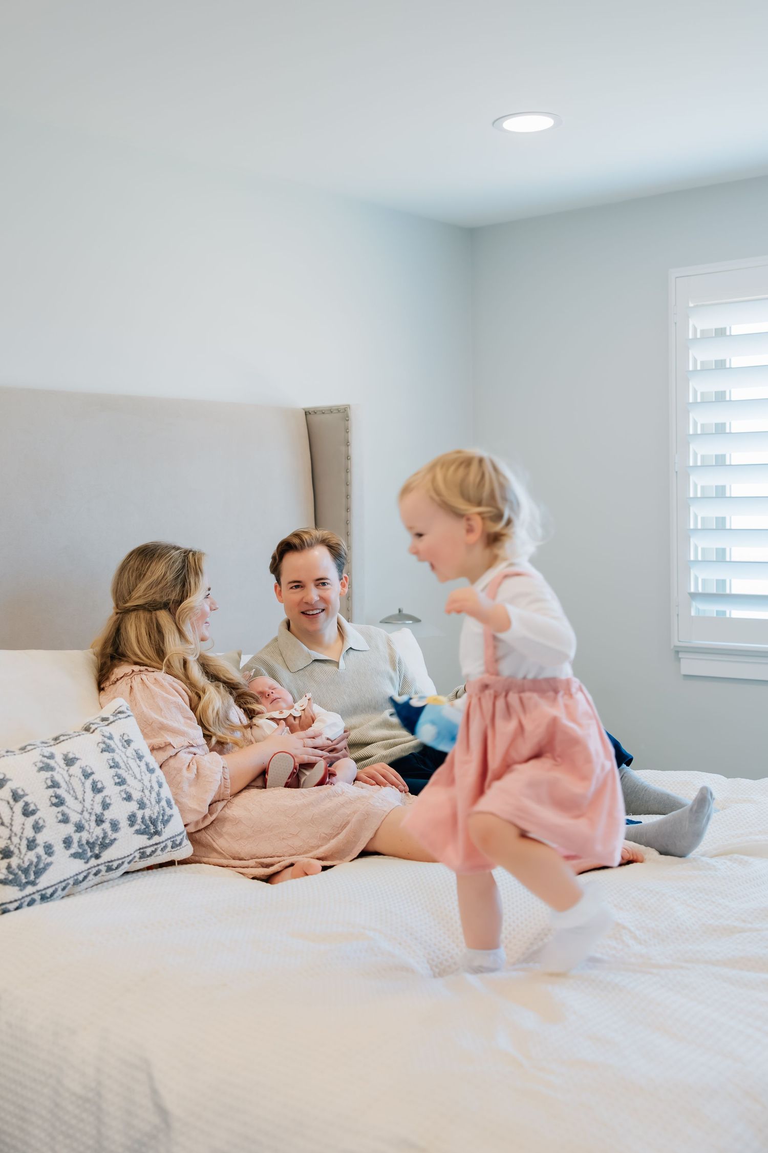 Lifestyle newborn photography of a small family in their infant's nursery