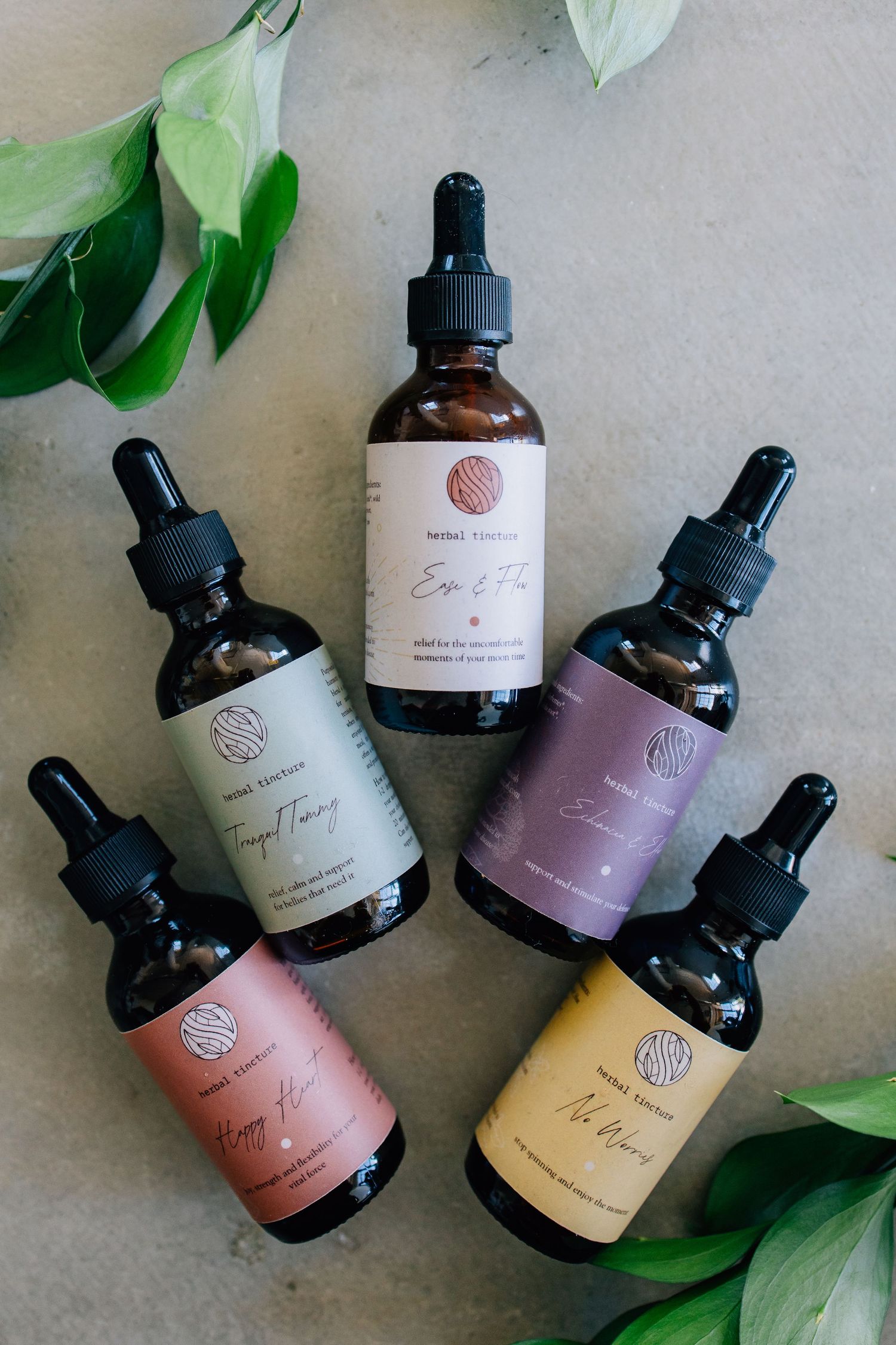 Branding photograph for an herbal remedy company featuring several bottles of their unique drops