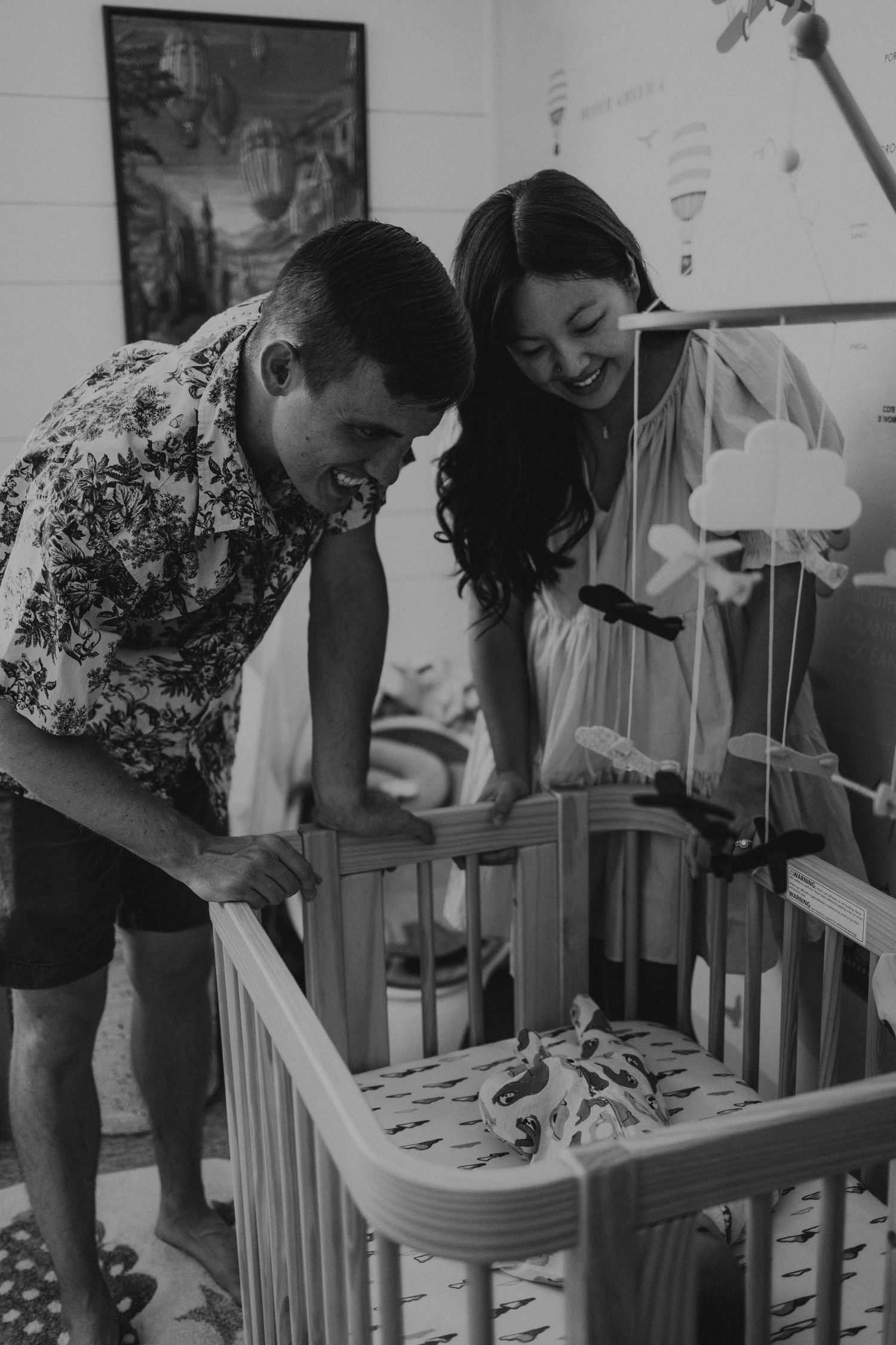 Lifestyle newborn photography of a small family in their infant's nursery