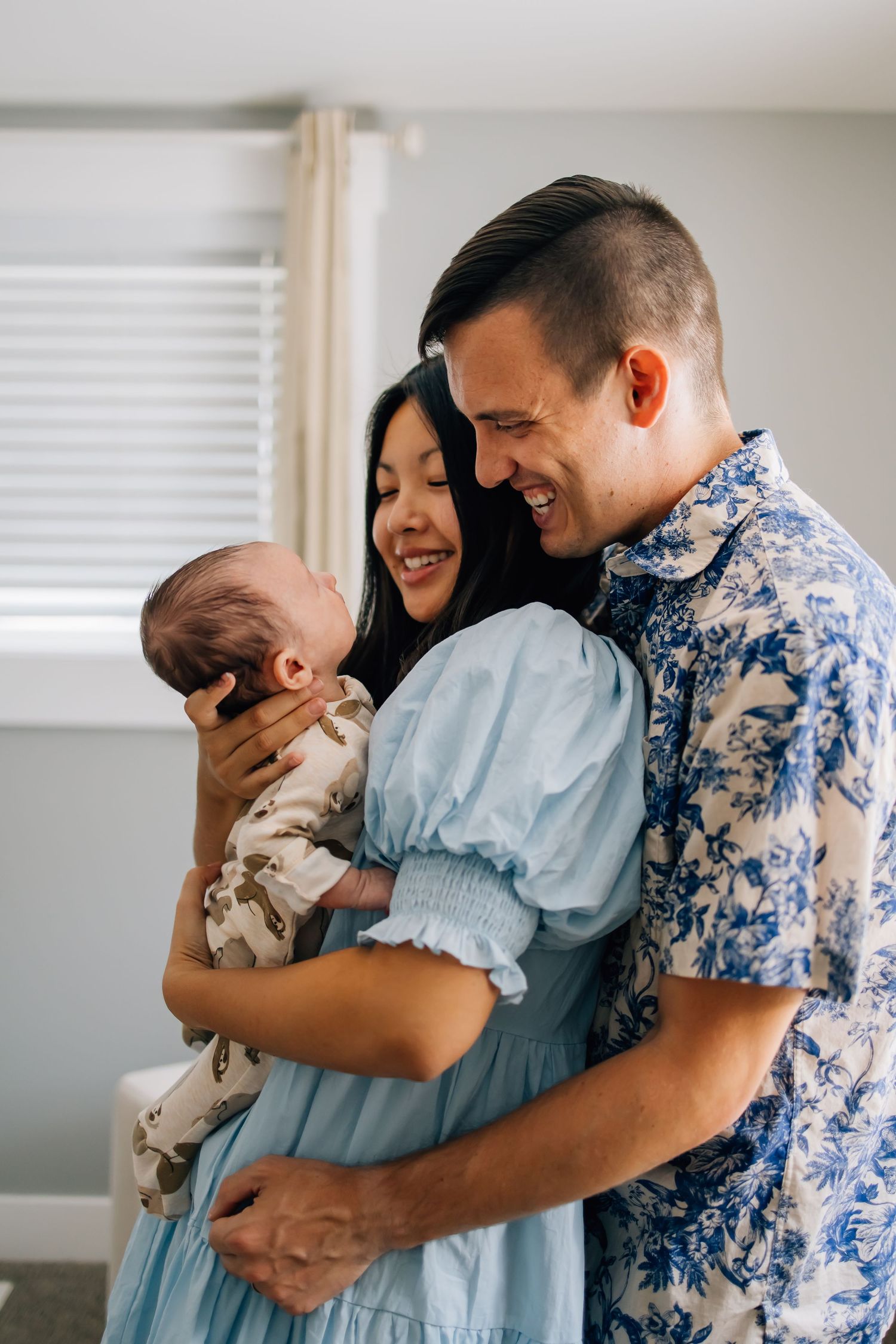 Lifestyle newborn photography of a small family in their infant's nursery