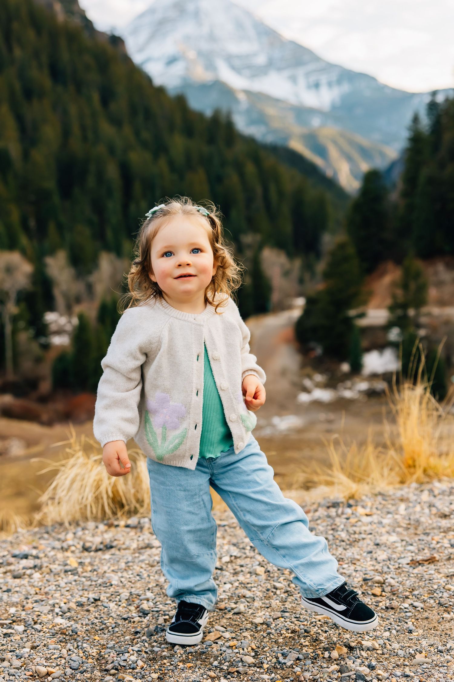 portrait photography of a small child in front of stunning mountain landscape