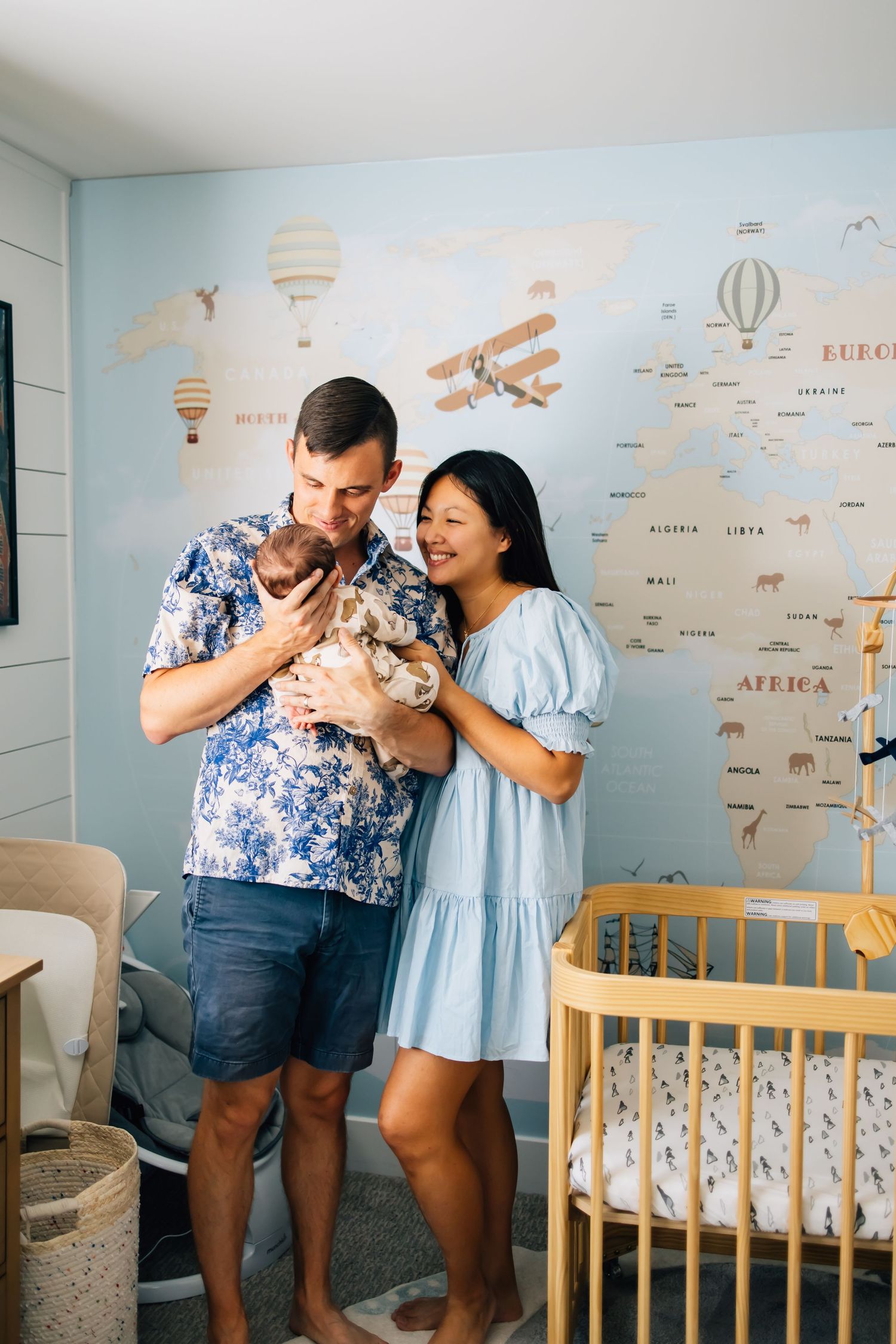 Lifestyle newborn photography of a small family in their infant's nursery