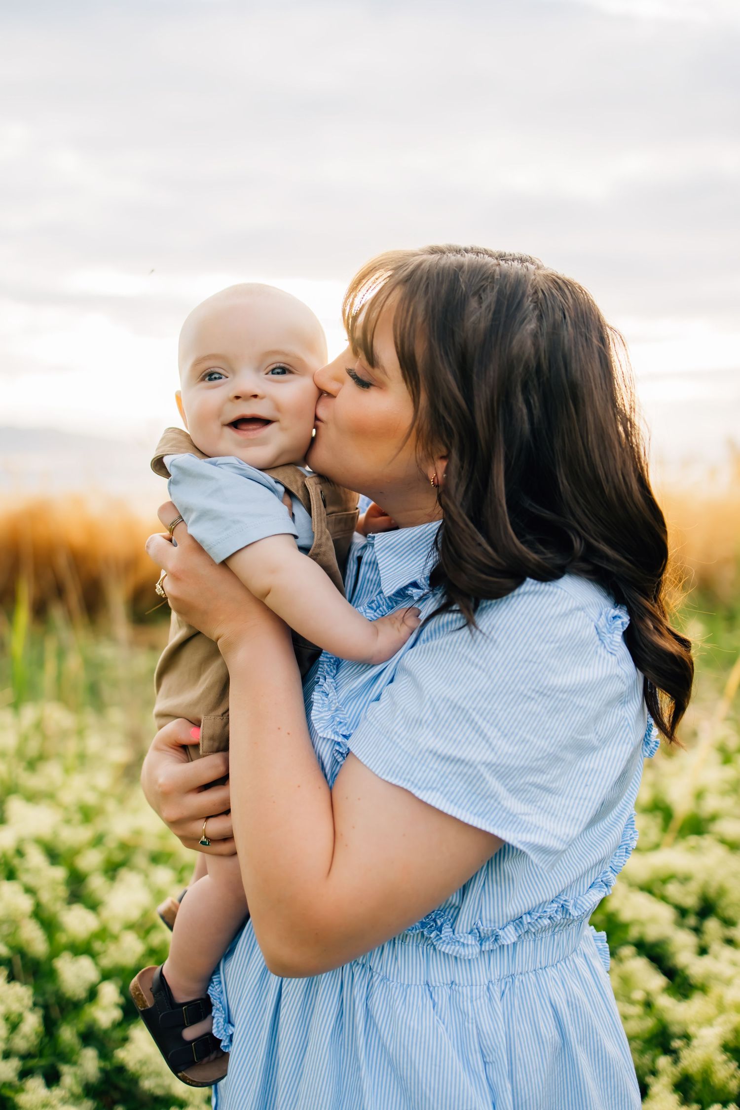 Family photography featuring a mother in a stunning baby blue dress in a Utah lake setting
