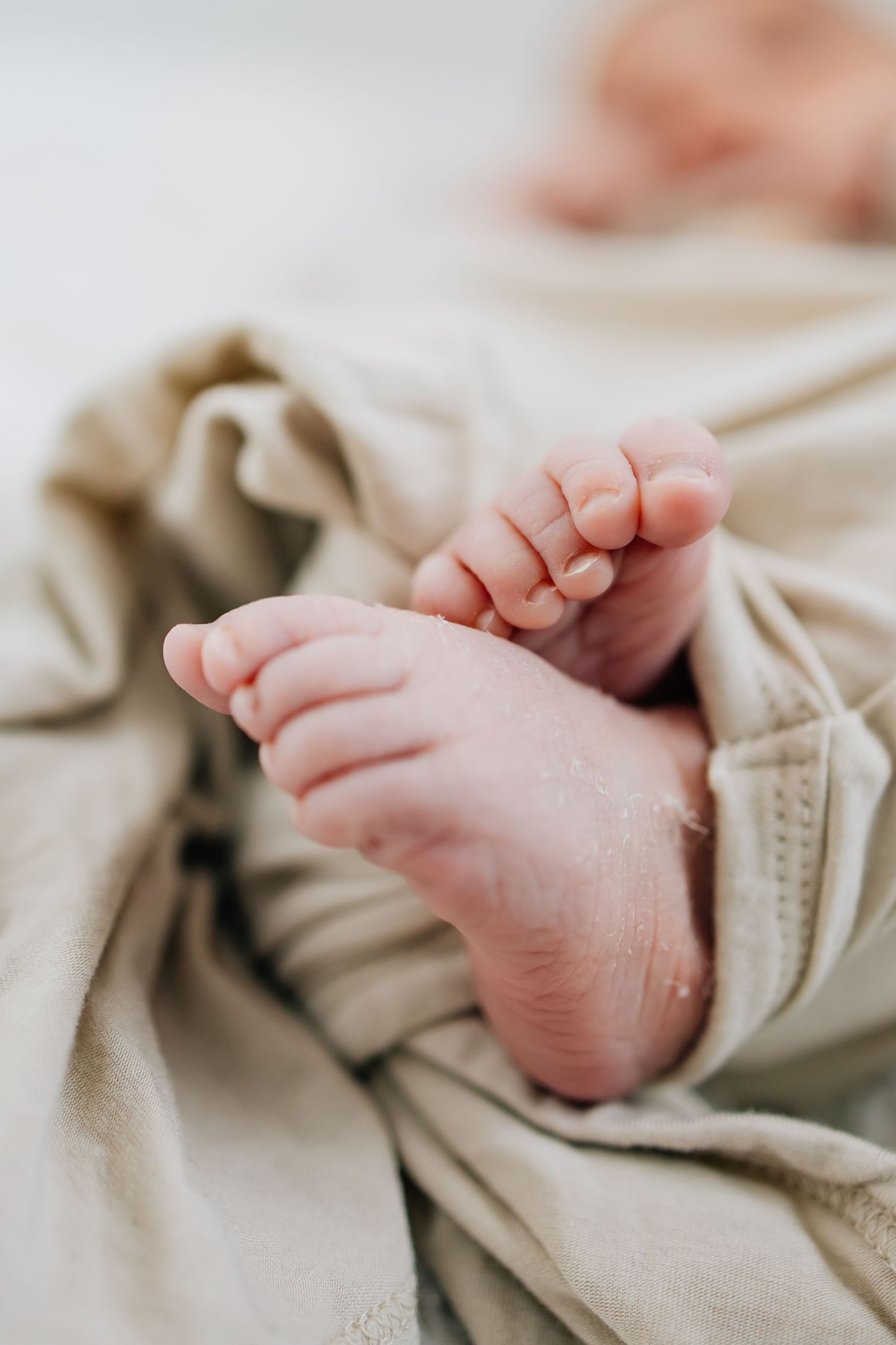 Newborn photography of a fresh baby's feet in the hospital