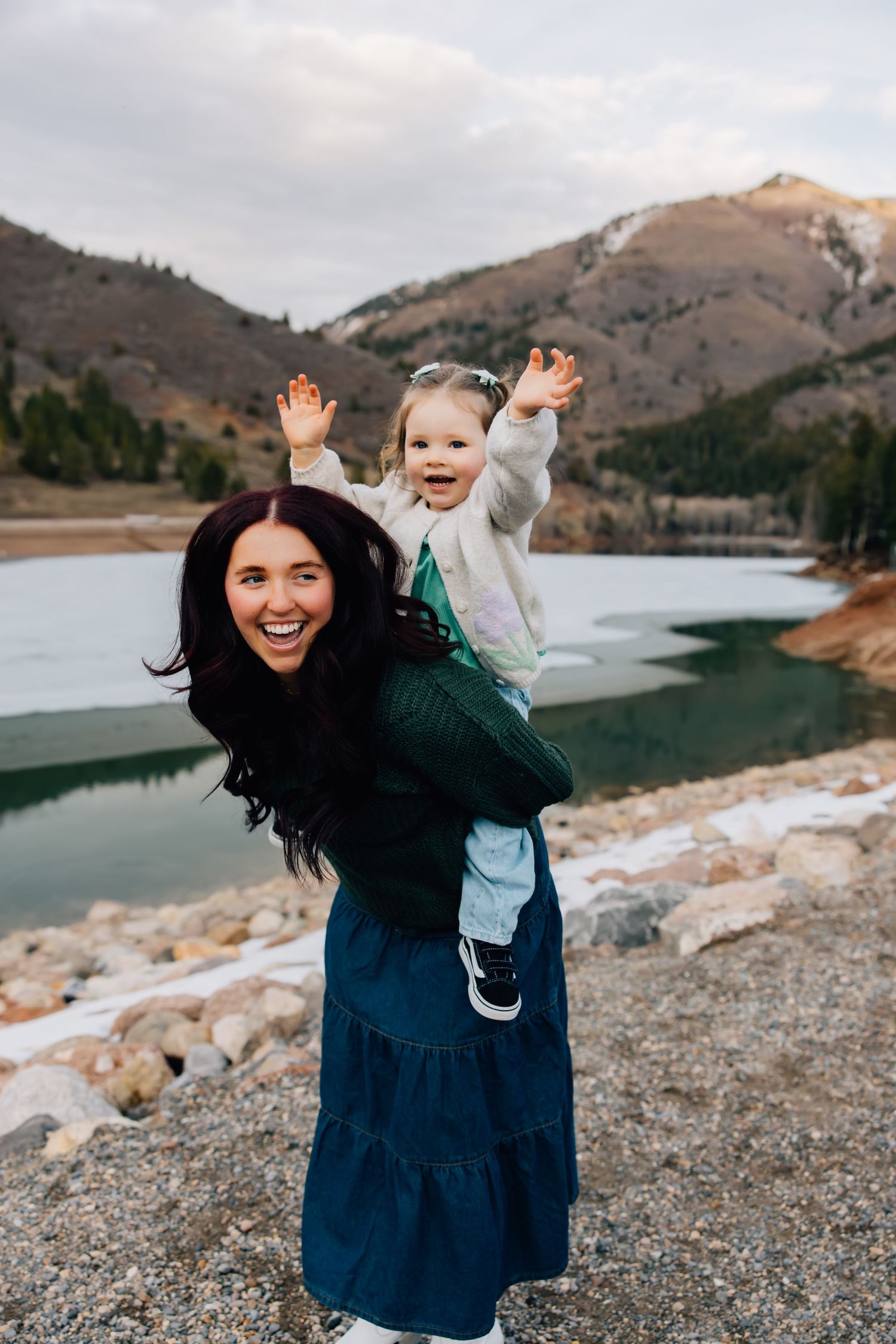 Portrait photography featuring a child going for a piggy back ride on young woman