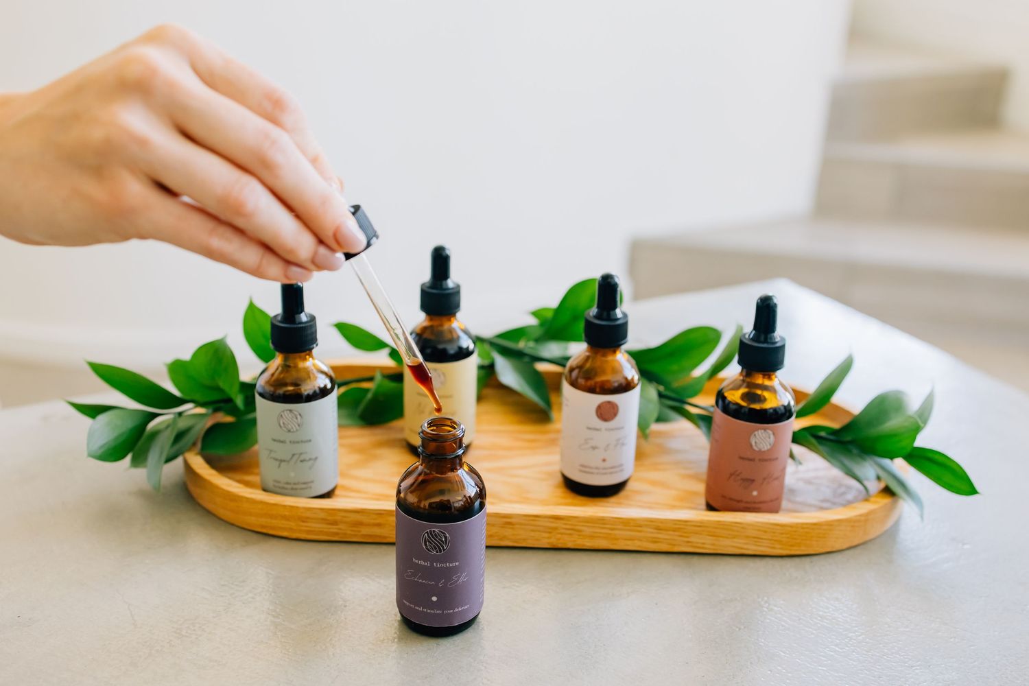 Branding photograph for an herbal remedy company featuring several bottles of their unique drops