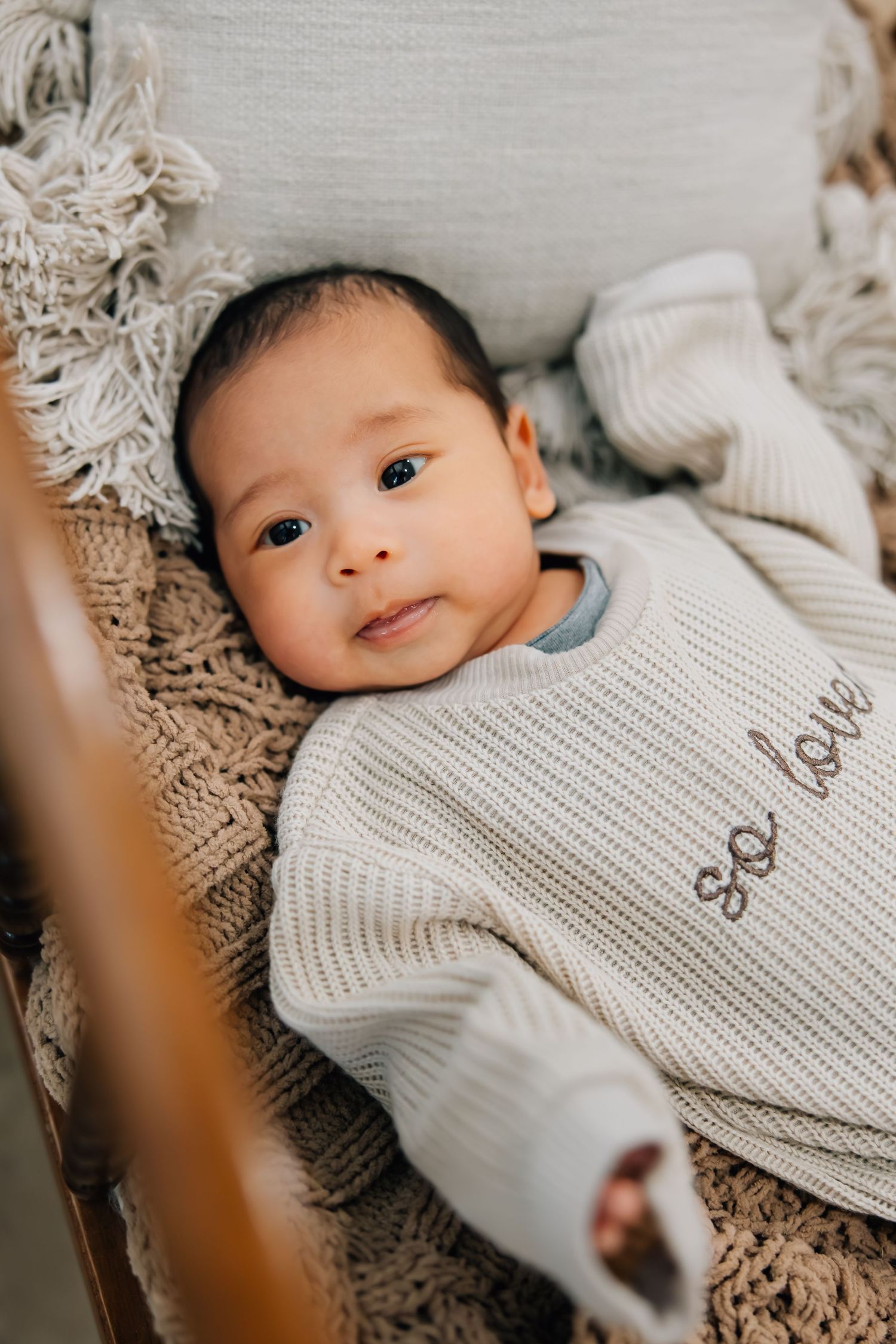 Portrait photography of a newborn in a small crib