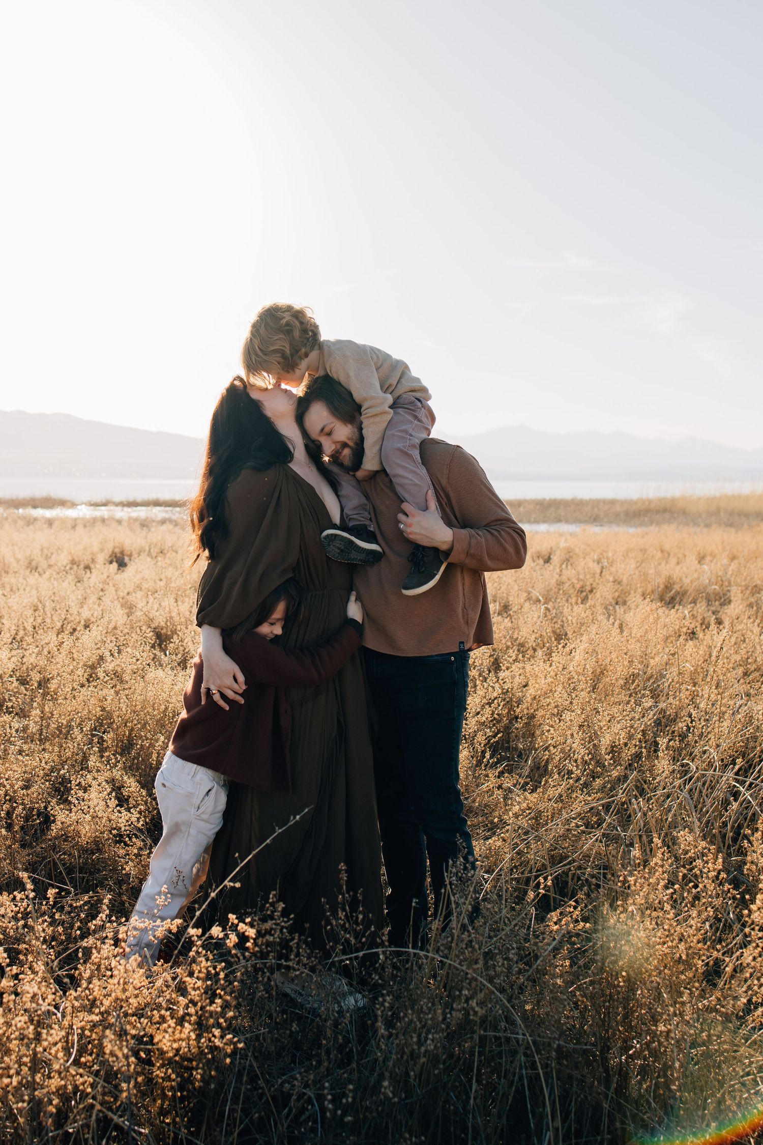 Family photography of a small family in the stunning landscape of utah lake