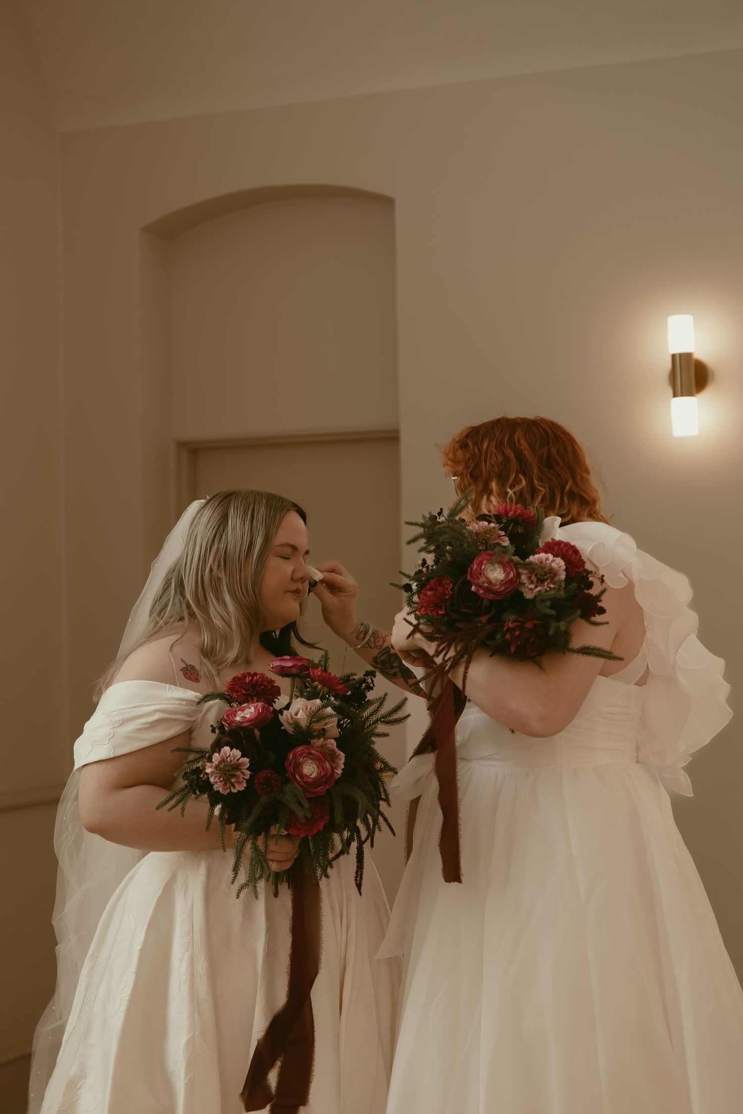 Bride fixing other brides makeup in Cleveland Ohio by Gypsy Lens Photography. Moody, filmy, vintage, documentary wedding photography.