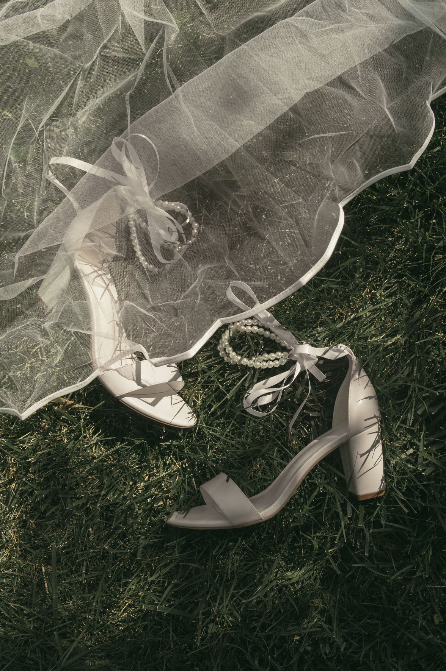 Detail photo of bride shoes in grass in Wooster Ohio by Gypsy Lens Photography. Moody, vintage, nostalgic, documentary wedding photography.