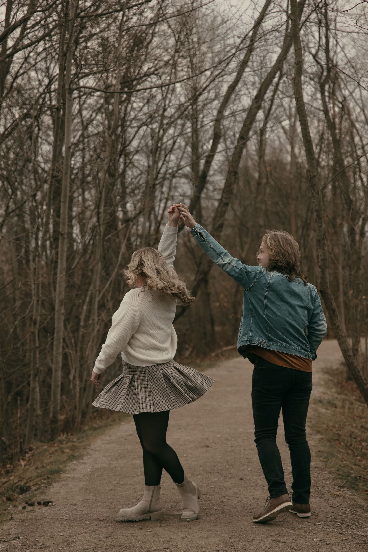 Couple dancing on a path in Lake County Ohio by Gypsy Lens Photography. Moody, filmy, vintage, documentary wedding photography