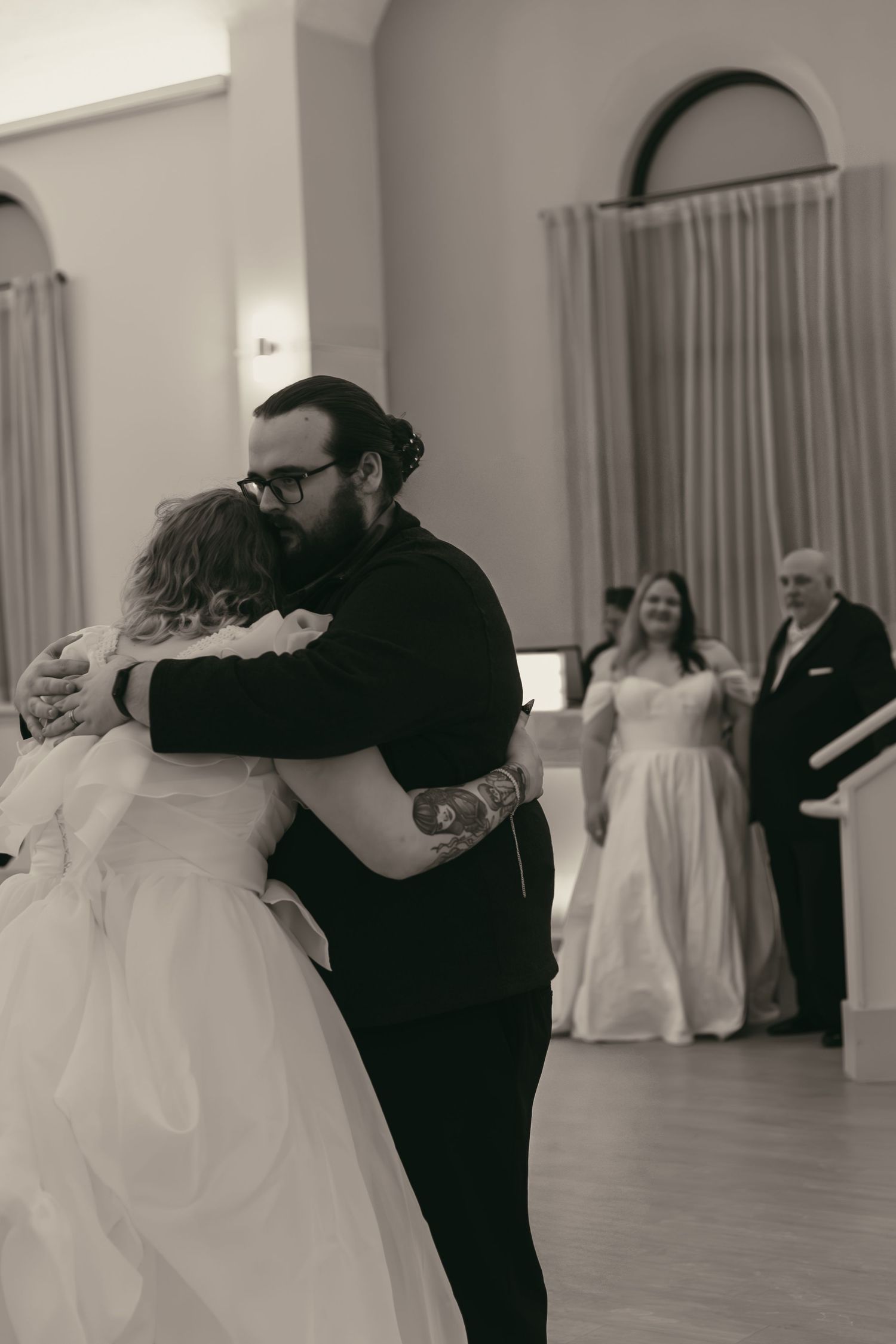 Bride dancing with family emotionally in Cleveland Ohio by Gypsy Lens Photography. Moody, filmy, vintage, documentary wedding photography.