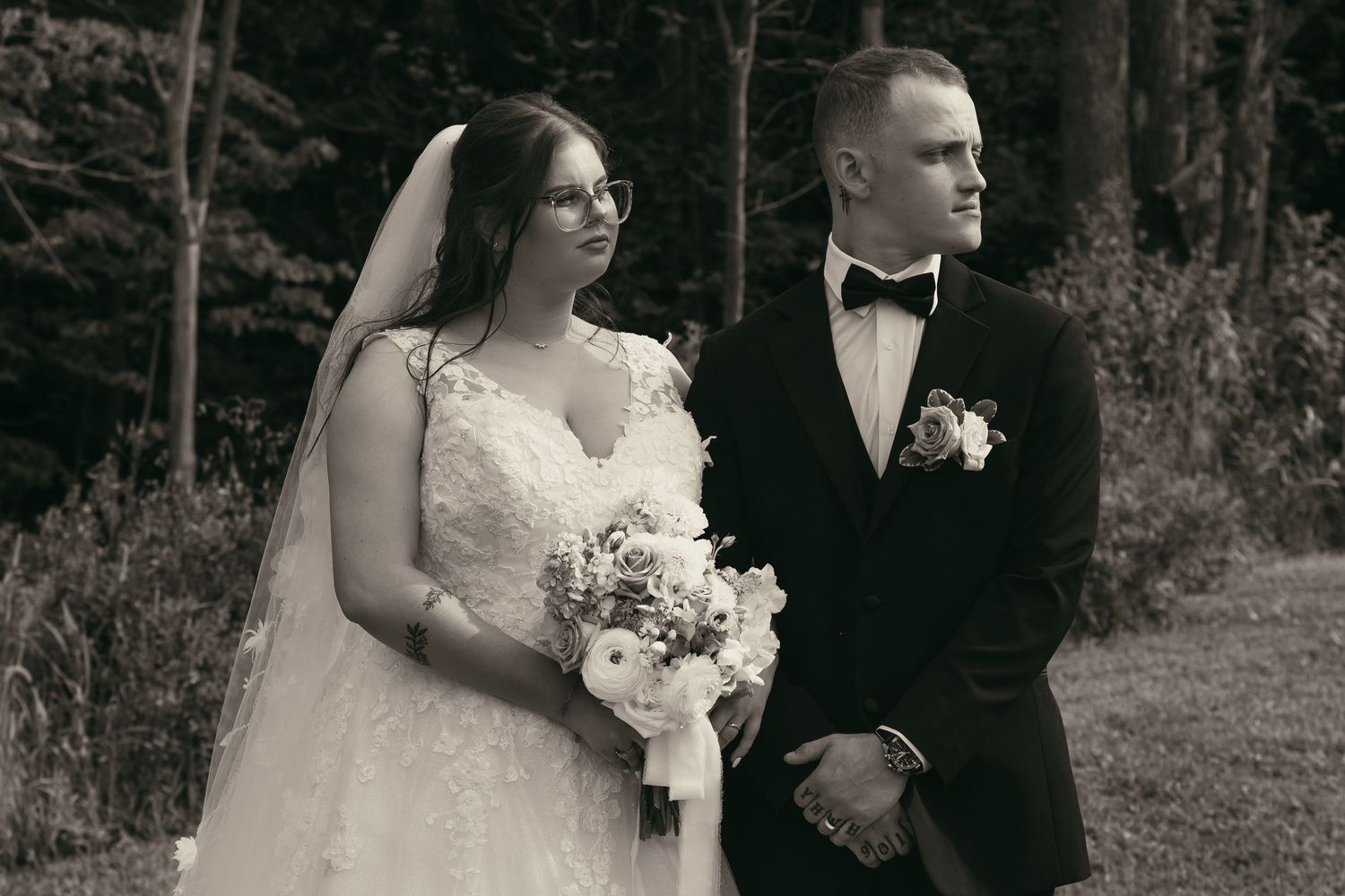 Wedding couple posing outdoors in a wooded setting with natural lighting by Gypsy Lens Photography, vintage documentary wedding photographer