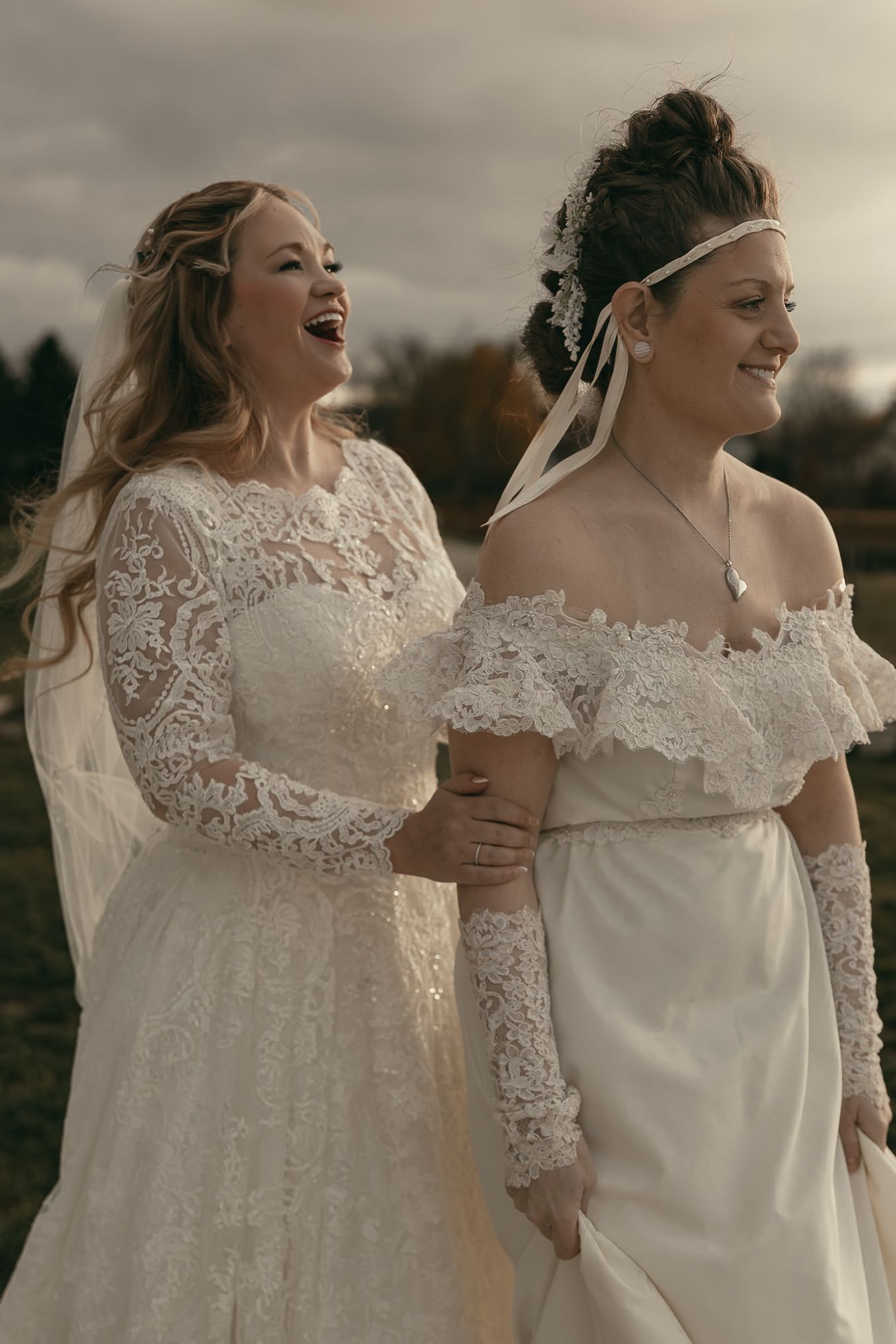 Two brides share a moment during first look in Lake County Ohio by Gypsy Lens Photography. Moody, vintage, documentary wedding photography.