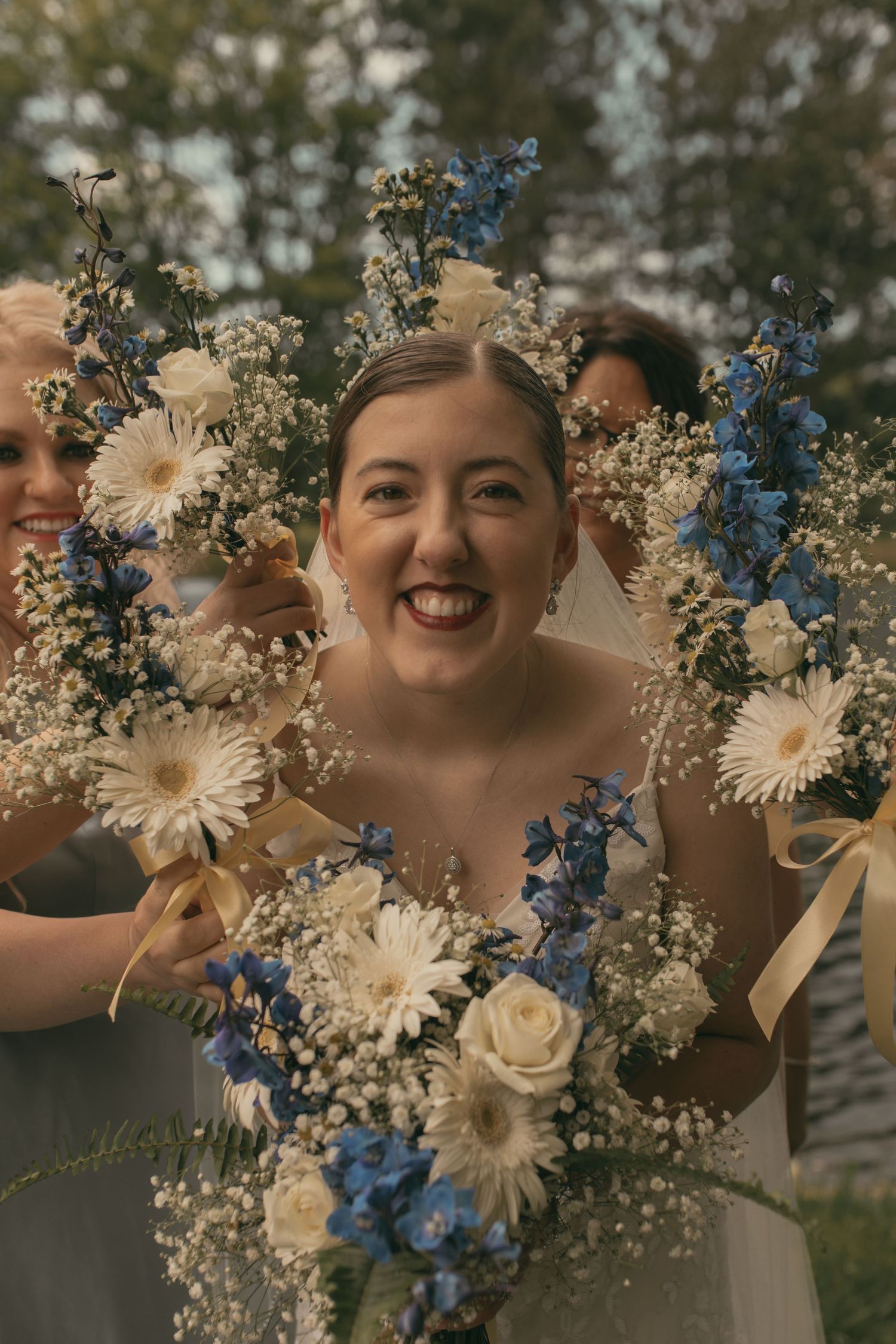 Wedding bouquets around bride in Ashtabula Ohio by Gypsy Lens Photography. Moody, nostalgic, vintage, documentary wedding photography.