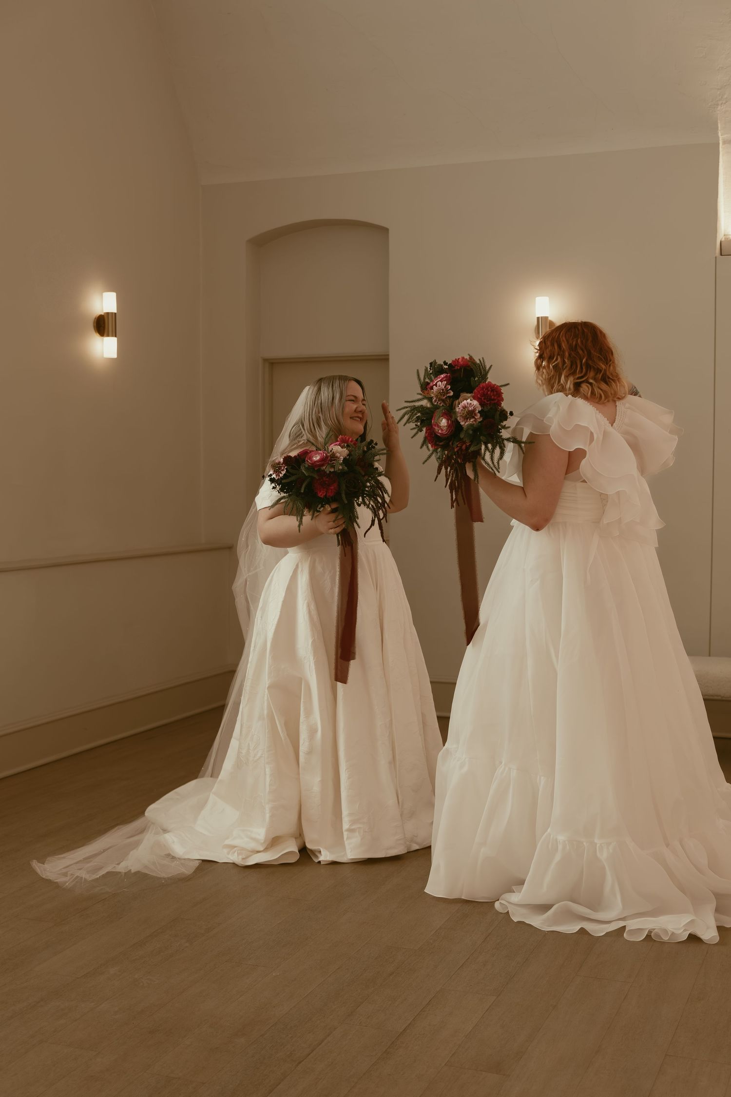 Two emotional brides during first look in Cleveland Ohio by Gypsy Lens Photography. Moody, filmy, vintage, documentary wedding photography.