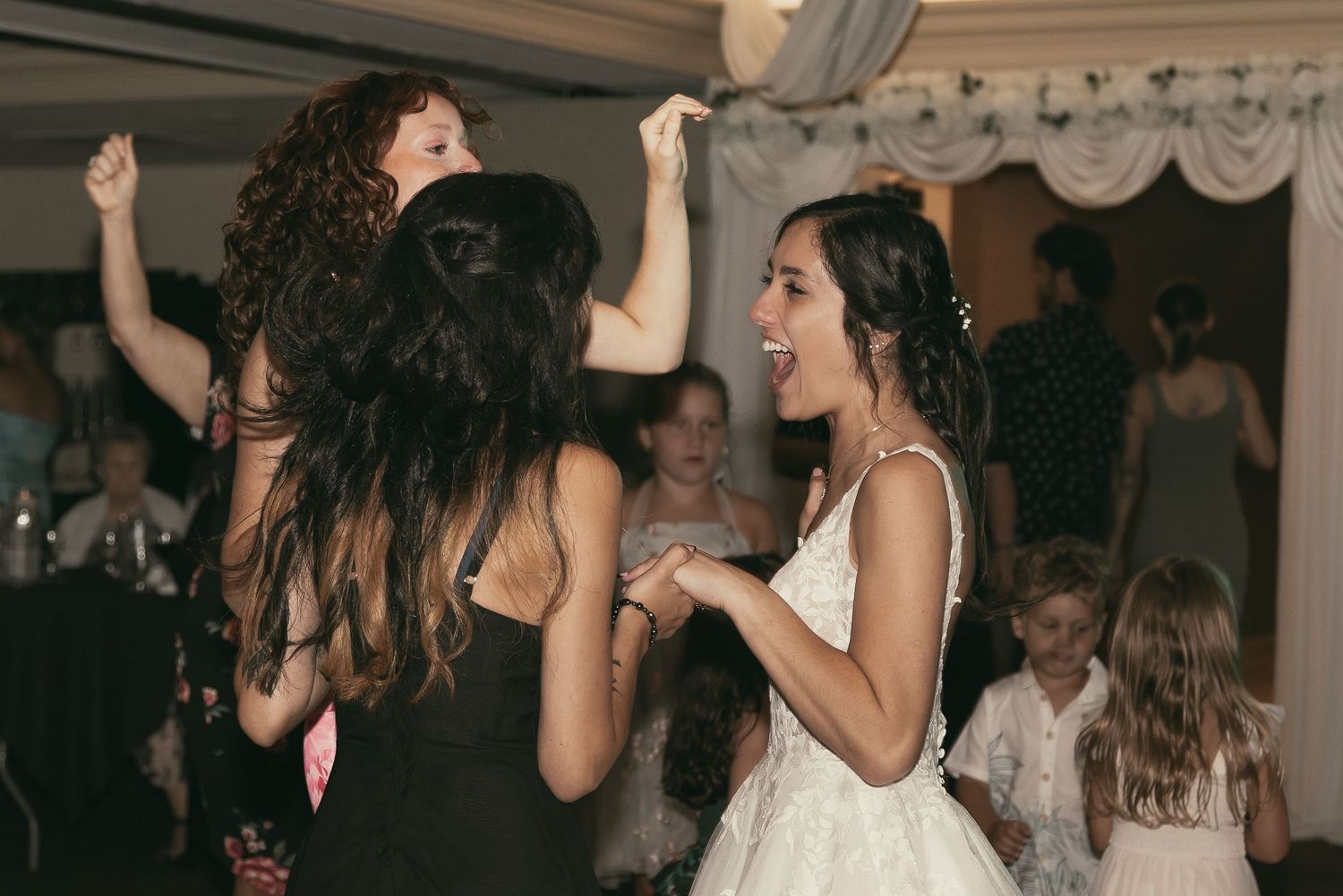 Excited wedding guests at reception in Tallmadge Ohio by Gypsy Lens Photography. Moody, vintage, nostalgic, documentary wedding.