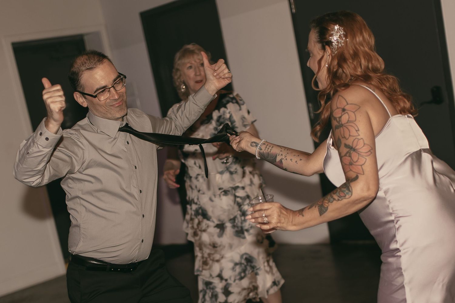 Wedding guests having fun at reception in Cleveland Ohio by Gypsy Lens Photography. Moody, vintage, documentary wedding photographer.