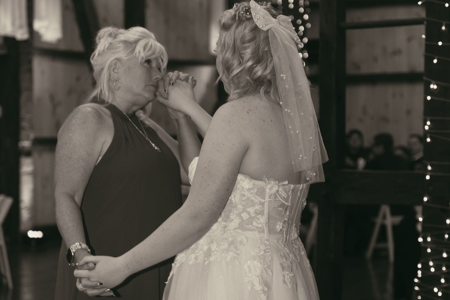 Bride and mom crying their first dance in Wooster Ohio by Gypsy Lens Photography. Moody, vintage, nostalgic, documentary wedding photography
