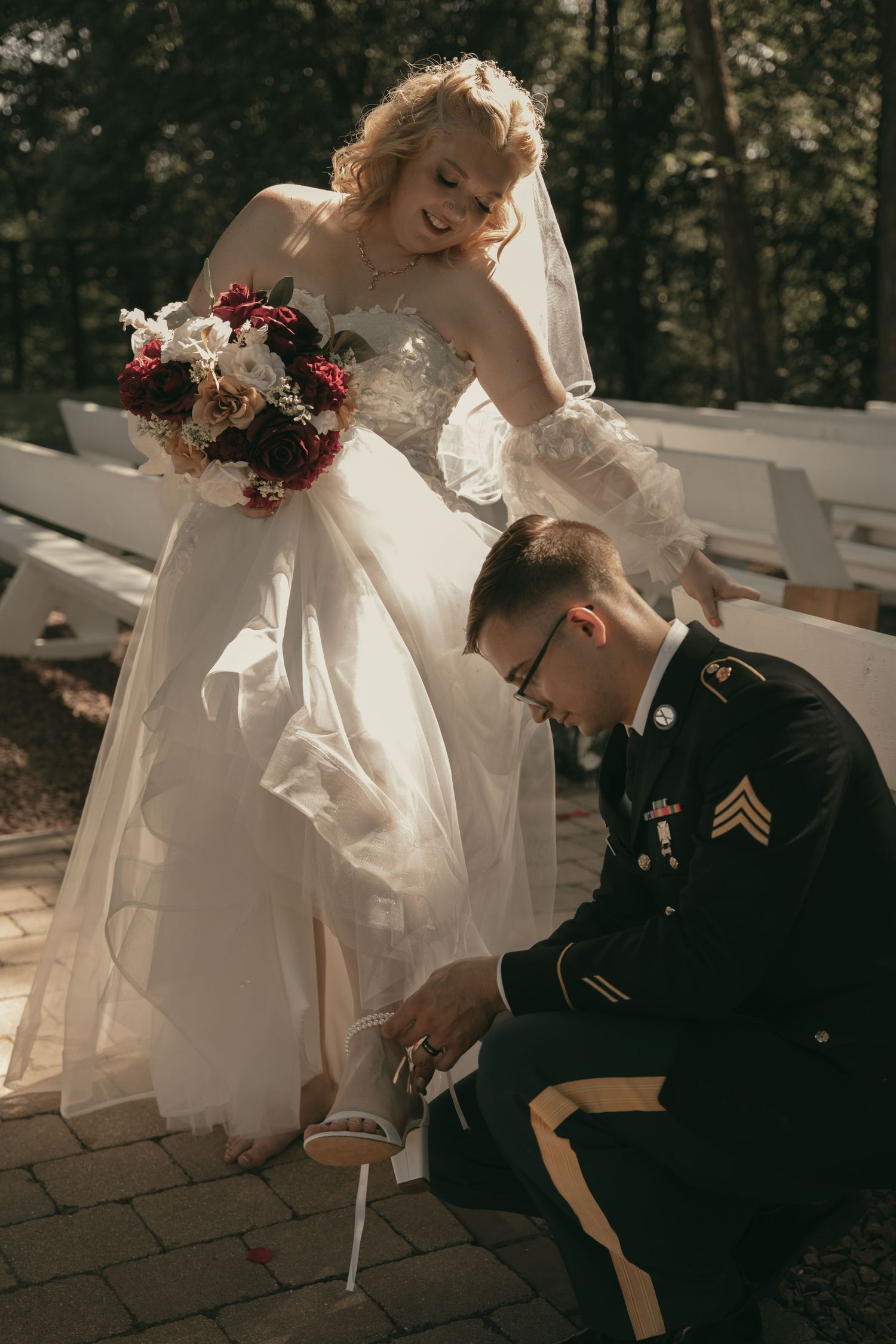 Groom helping bride with shoes romantic moment in Wooster Ohio by Gypsy Lens Photography. Moody, vintage, nostalgic, documentary wedding.