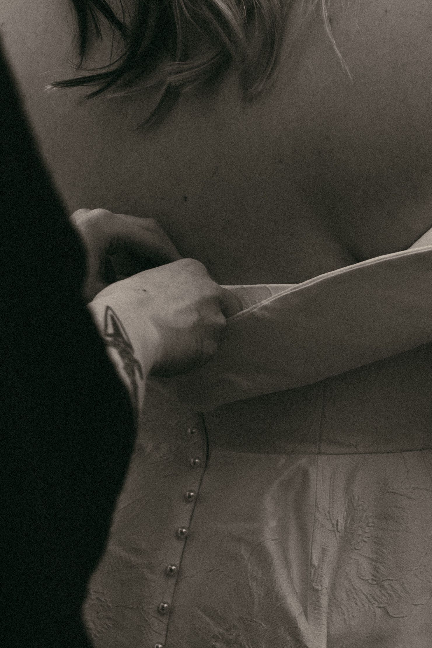 Close up of bride getting into dress in Cleveland Ohio by Gypsy Lens Photography. Moody, filmy, vintage, documentary wedding photography.