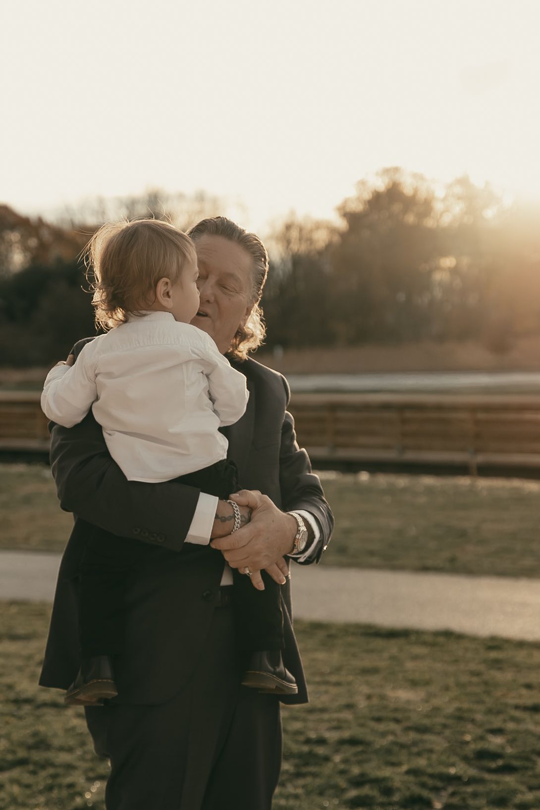 Cinematic sunset family portraits at wedding in Lake County Ohio by Gypsy Lens Photography. Moody, vintage, documentary wedding photography.
