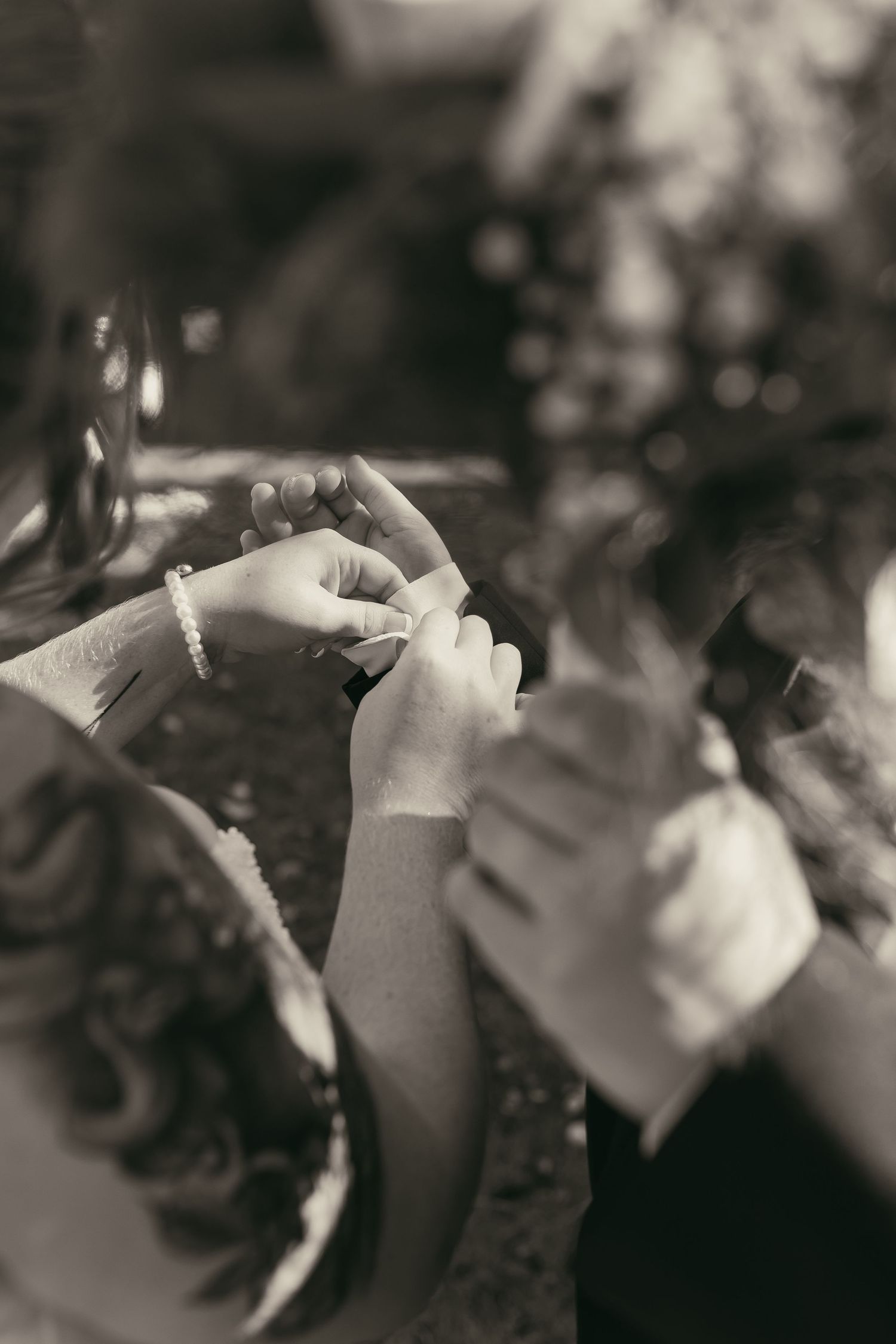 Bride fixing cuff links on wedding day in Cleveland Ohio by Gypsy Lens Photography. Moody, vintage, documentary wedding photography.