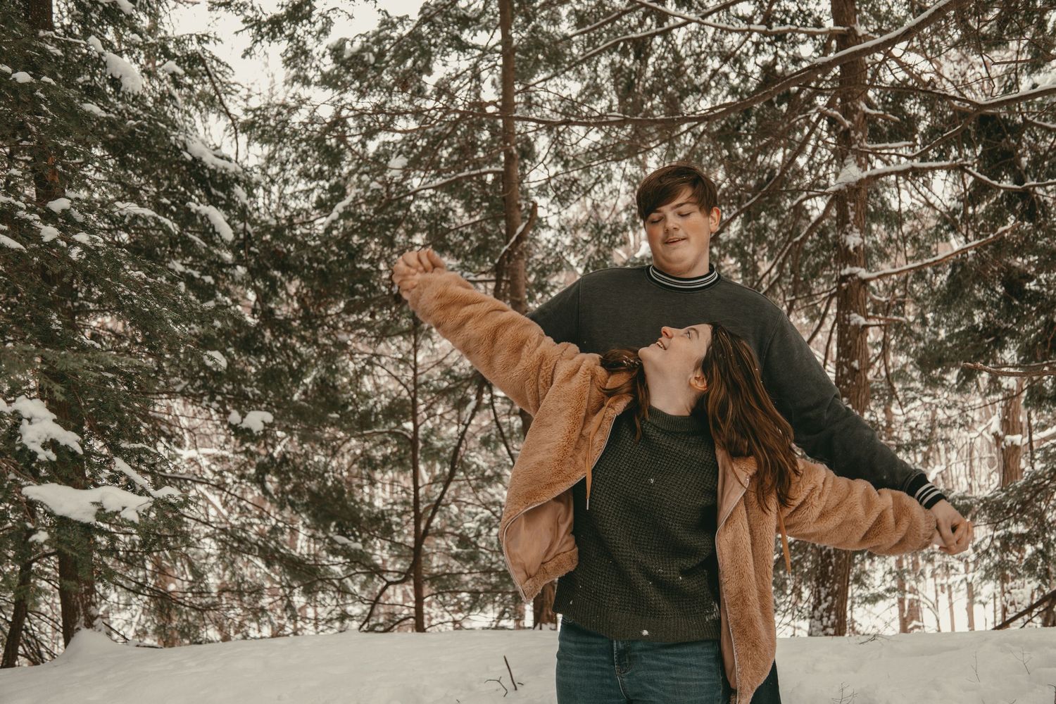 A playful moment at engagement session in Lake County Ohio by Gypsy Lens Photography. Moody, vintage, documentary wedding photographer.
