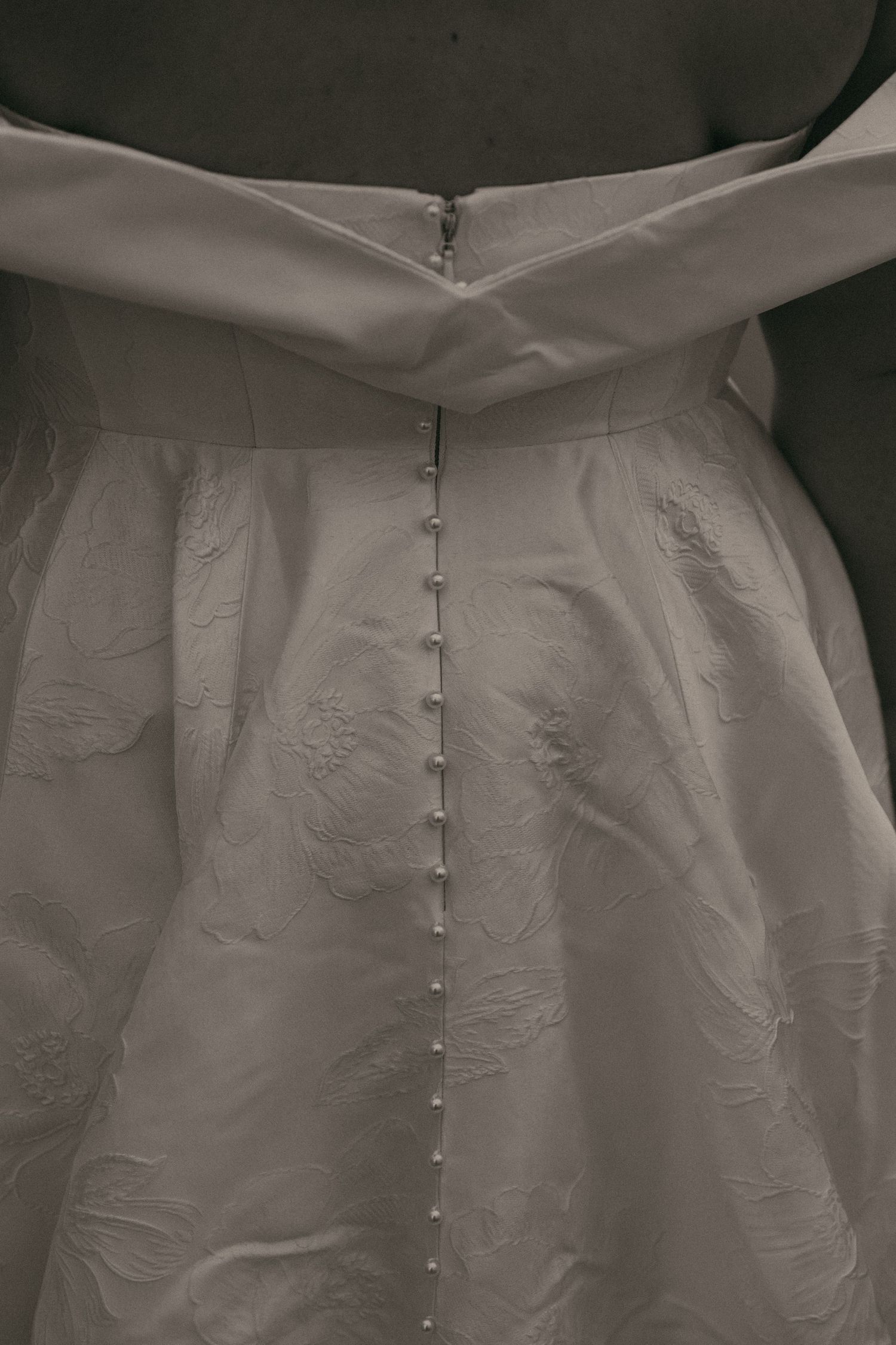 Close up of lace and buttons on dress in Cleveland Ohio by Gypsy Lens Photography. Moody, filmy, vintage, documentary wedding photography.