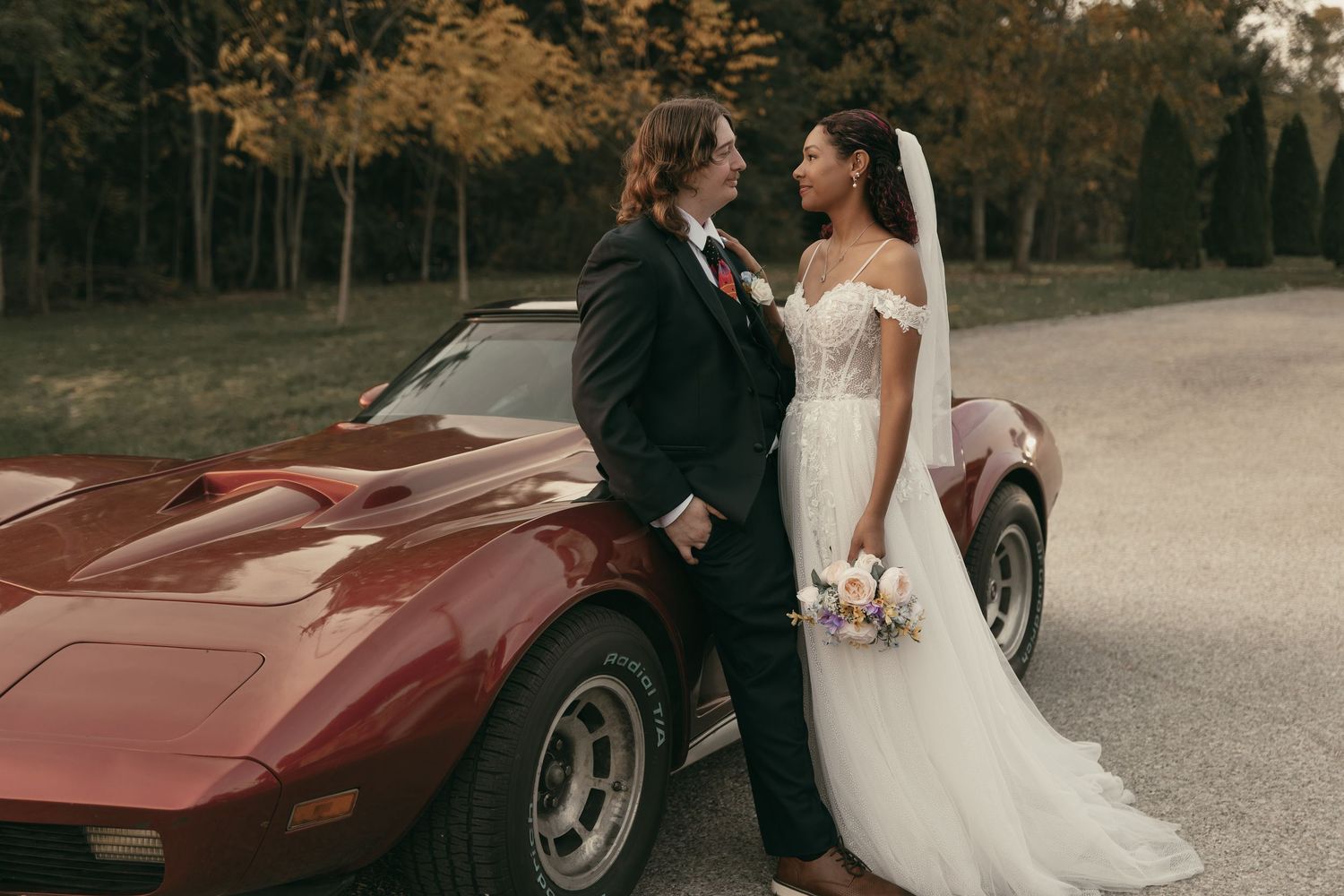 Couple with vintage car smiling in Cleveland Ohio by Gypsy Lens Photography. Moody, nostalgic, vintage, documentary wedding photography