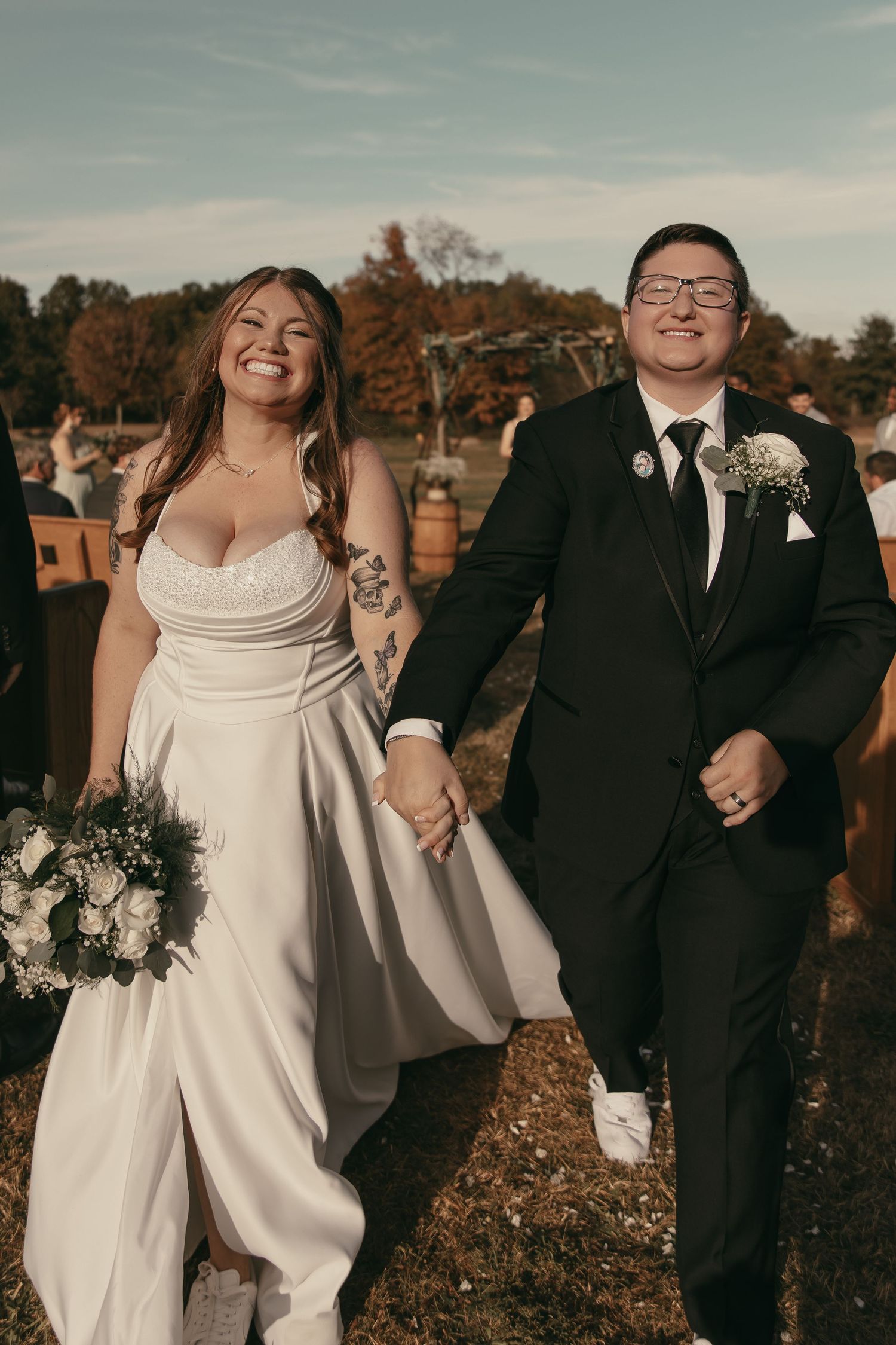 Candid LGBTQ couple having a happy moment just after being married, walking back down the aisle in Cleveland Ohio by Gypsy Lens Photography