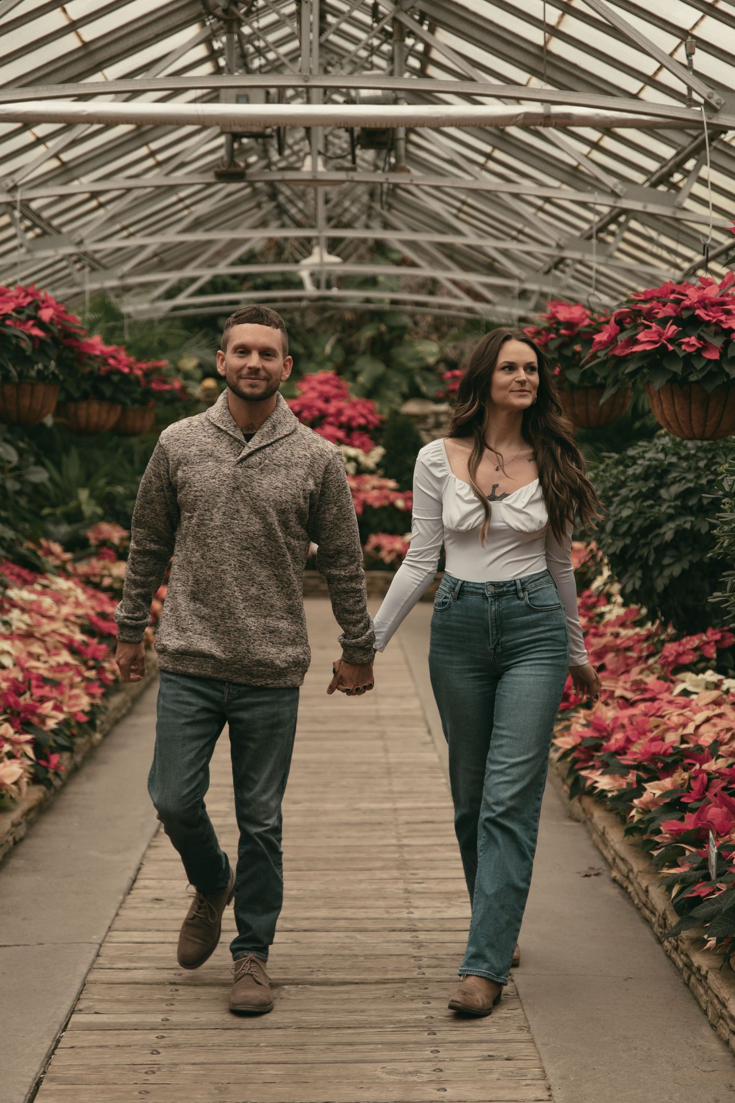 Couple walking around at greenhouse in Cleveland Ohio by Gypsy Lens Photography. Moody, filmy, vintage, documentary wedding photography