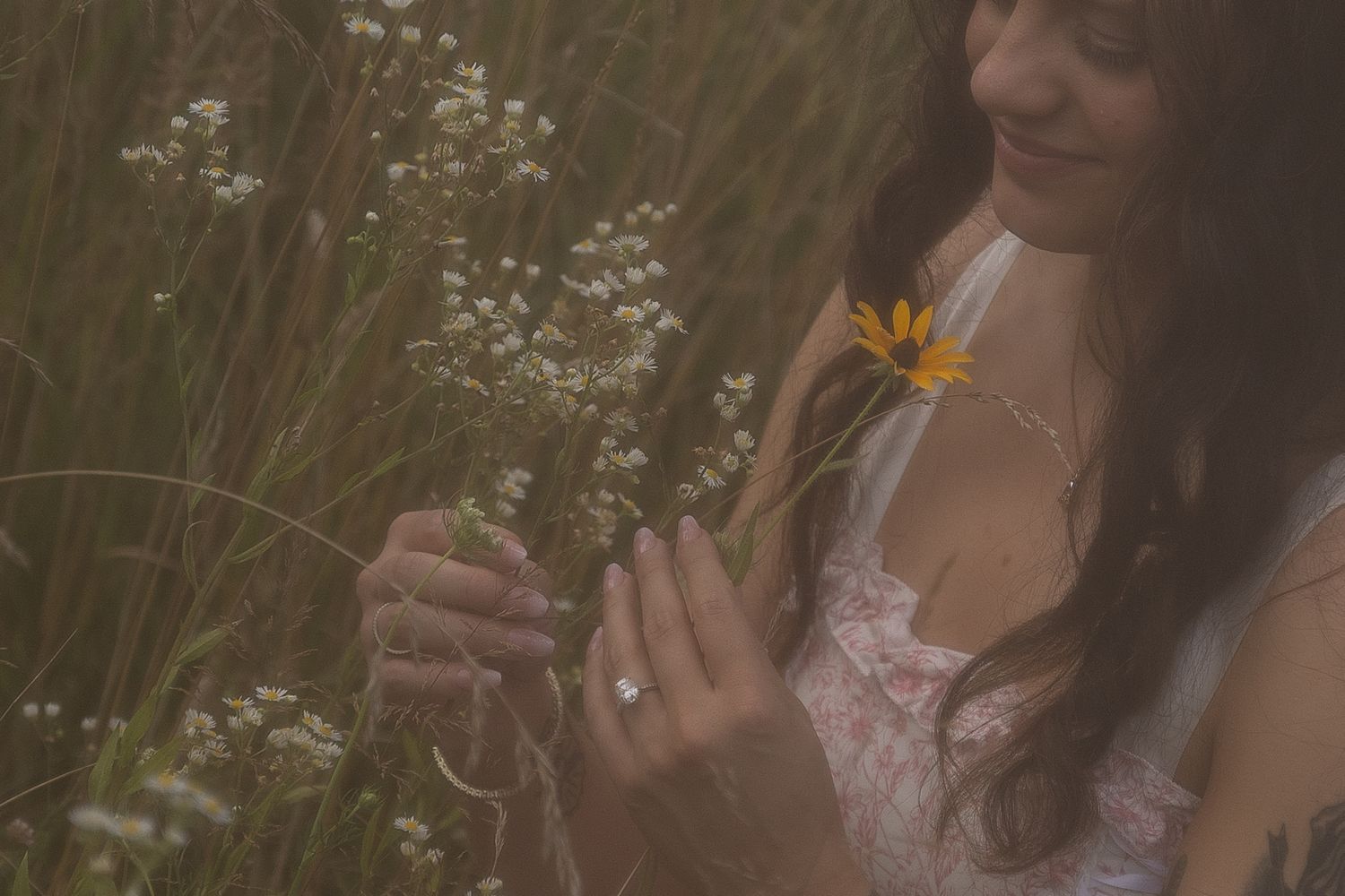 Detail ring photo of engaged woman in flower field in Lake County Ohio by Gypsy Lens Photography. Moody, filmy, vintage, documentary.