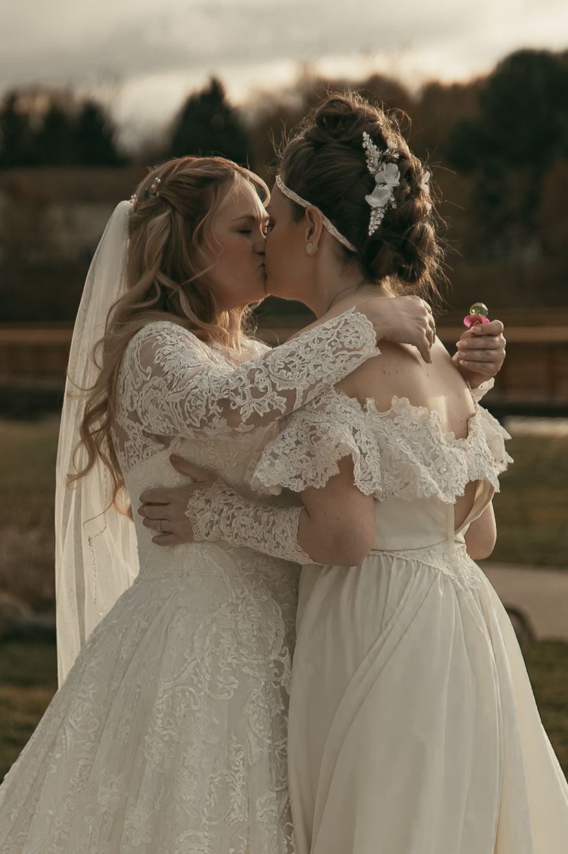 Two brides kissing during first look in Lake County Ohio by Gypsy Lens Photography. Moody, vintage, documentary wedding photography.