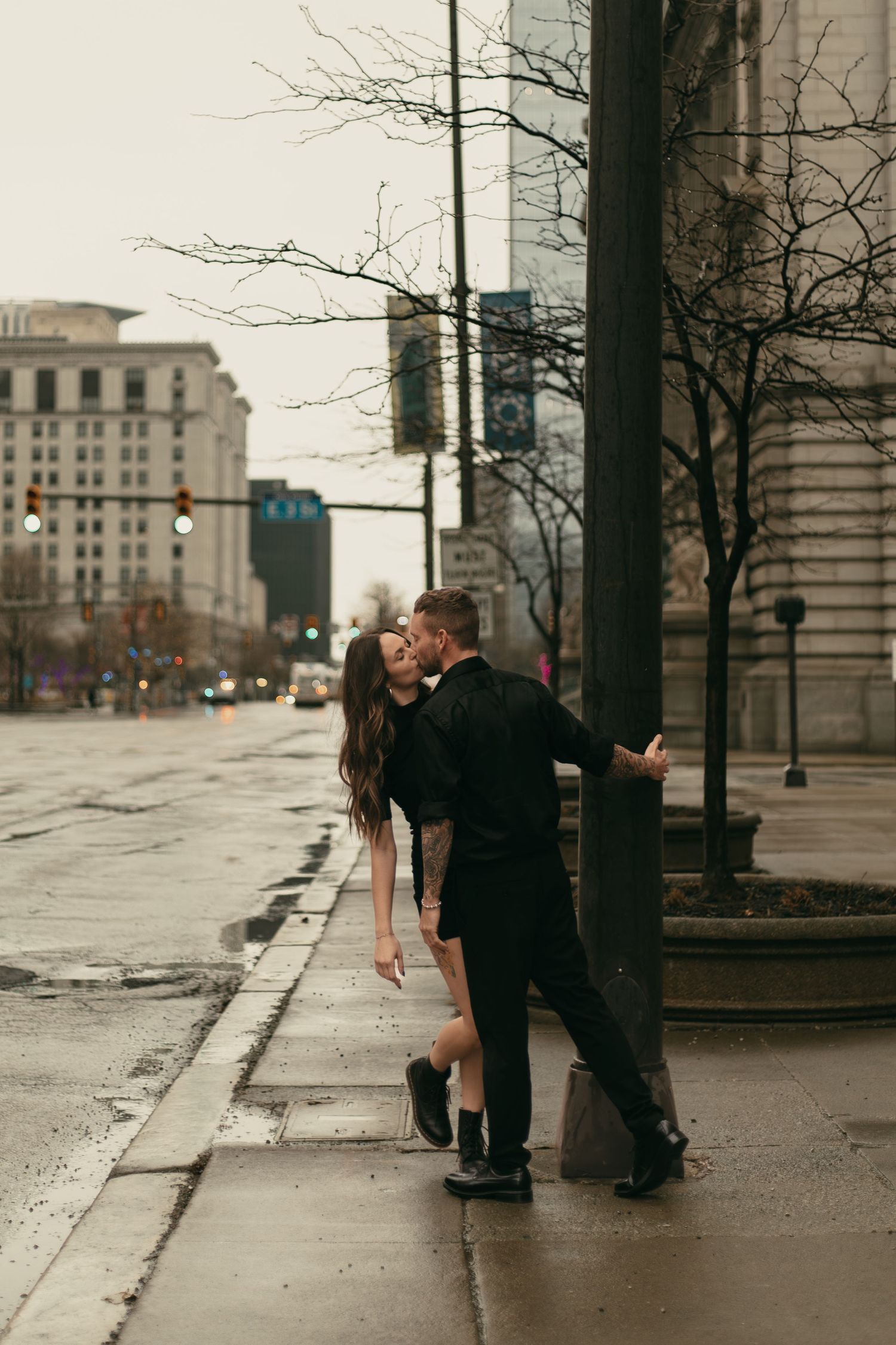 Couple kissing at light in big city of Cleveland Ohio by Gypsy Lens Photography. Moody, nostalgic, vintage, documentary wedding photography