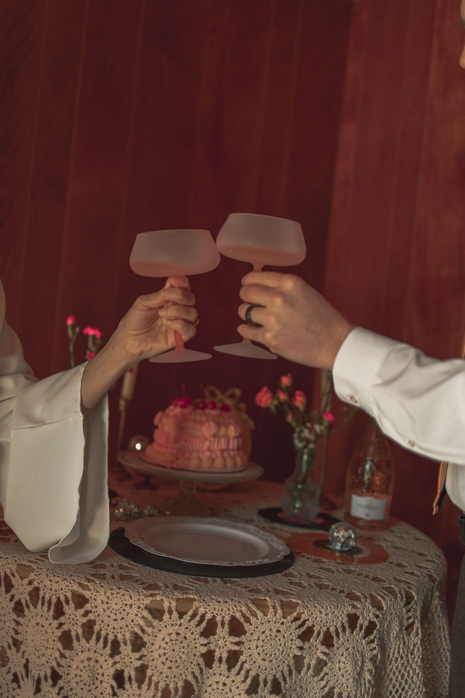 Couple toasting with glasses before cake cutting in Akron Ohio by Gypsy Lens Photography. Moody, nostalgic, documentary wedding photography.