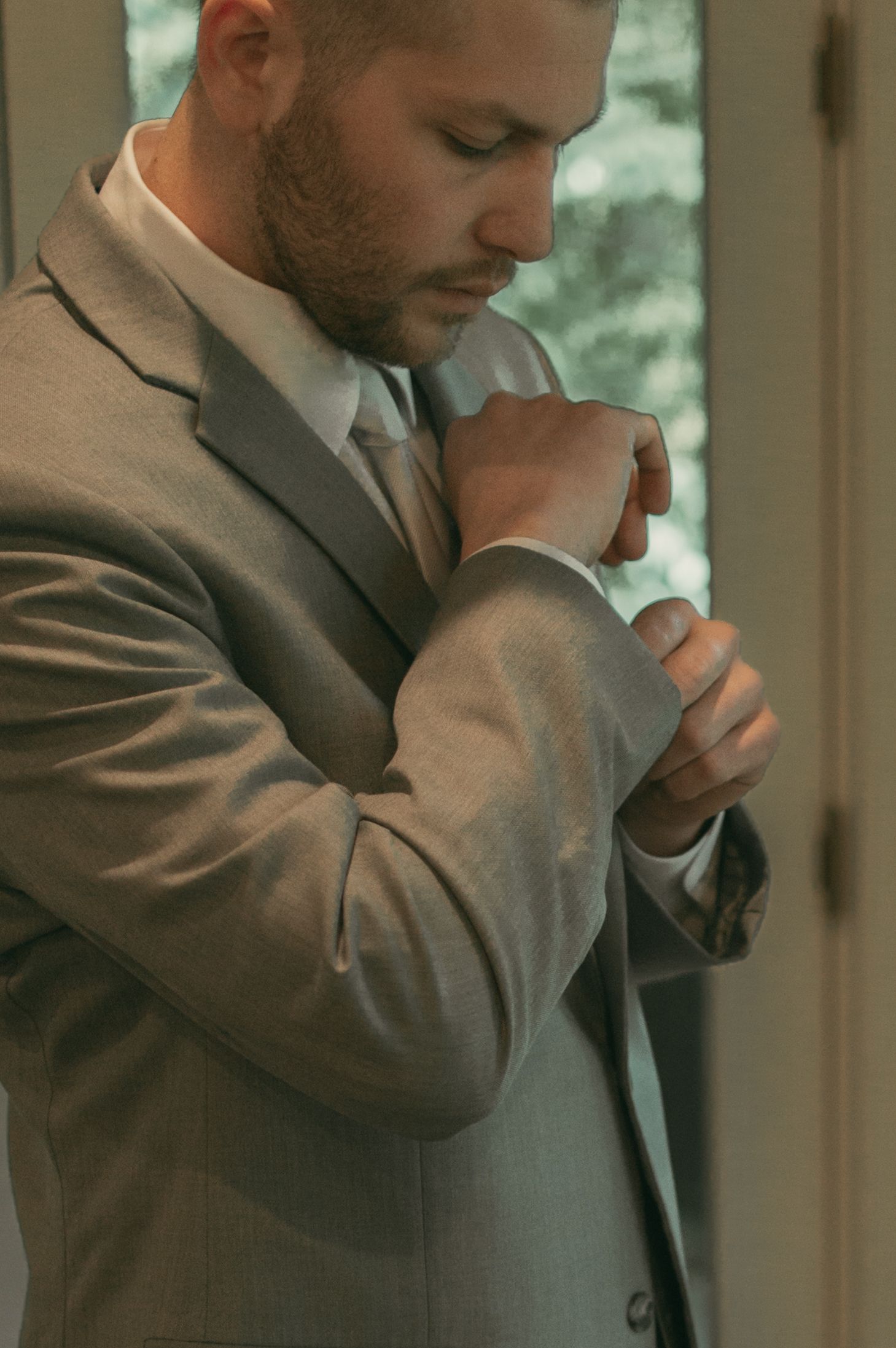 Groom getting ready on wedding day in Ashtabula Ohio by Gypsy Lens Photography. Moody, nostalgic, documentary wedding photography.