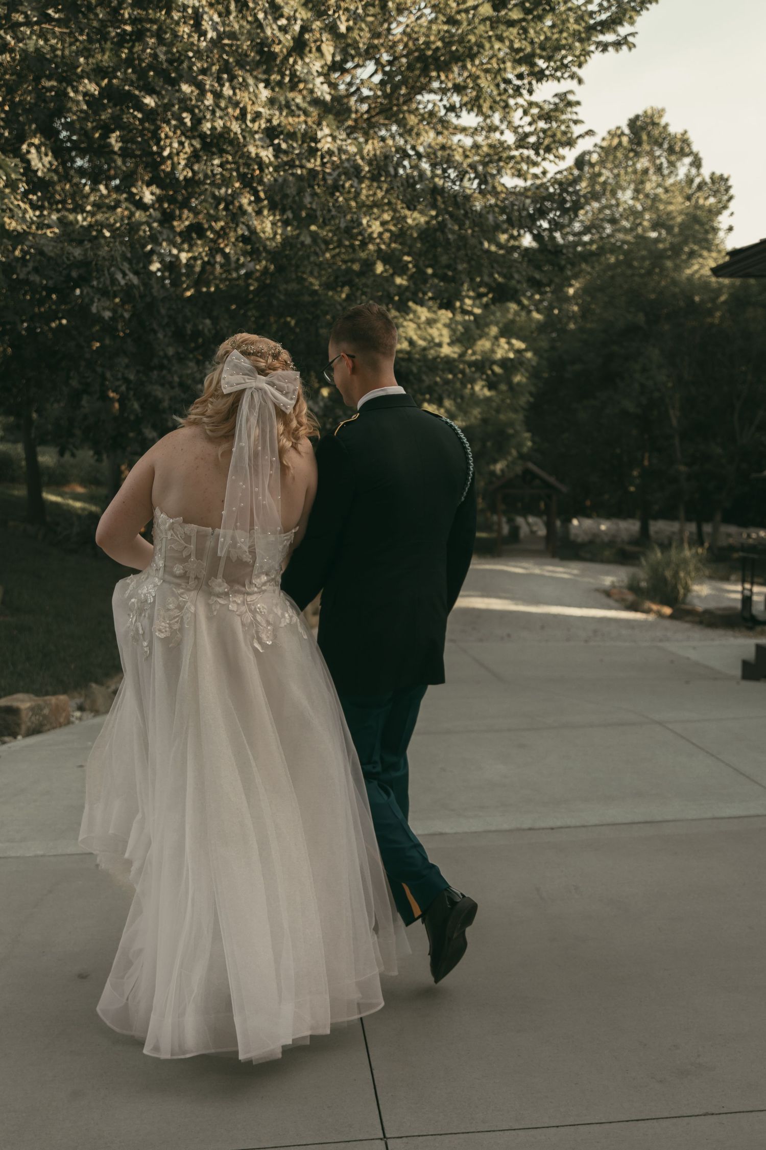 A bride and groom walk together in Wooster Ohio by Gypsy Lens Photography. Moody, nostalgic, vintage, wedding photographer.