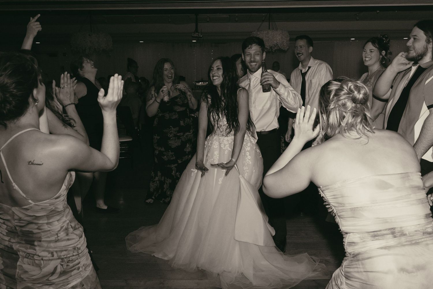 Wedding party dancing at reception party in Tallmadge Ohio by Gypsy Lens Photography. Moody, vintage documentary wedding