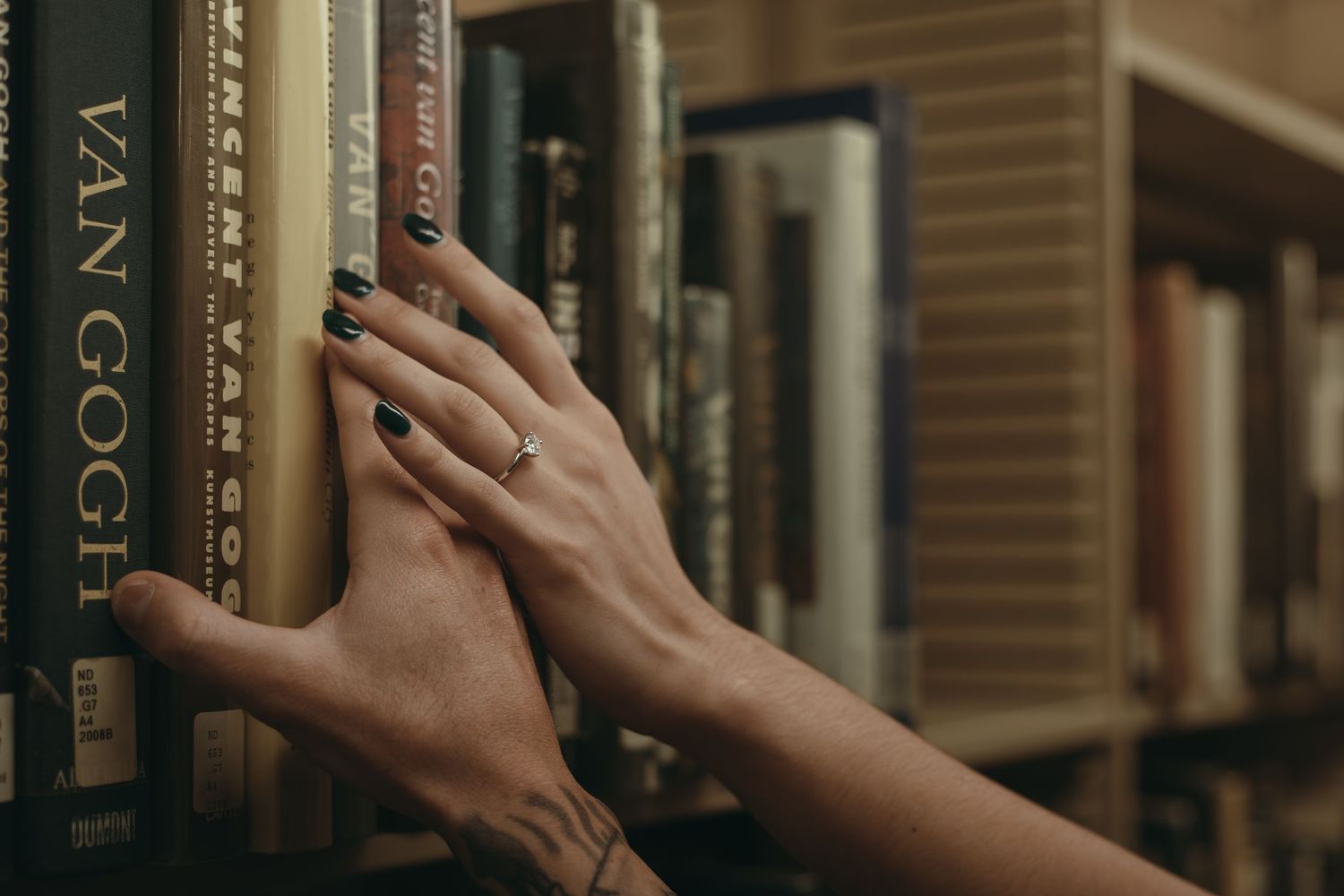 Engaged couple at library, ring detail in Cleveland Ohio by Gypsy Lens Photography. Moody, filmy, vintage, documentary wedding photography