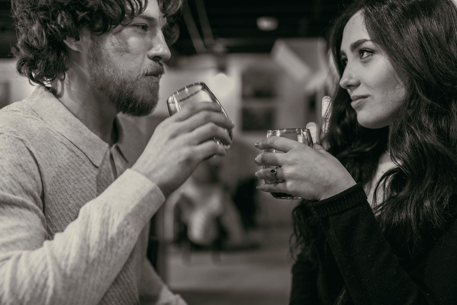Engaged couple enjoying wine at wine cellar in Cleveland Ohio by Gypsy Lens Photography. Moody, vintage, documentary wedding photographer.