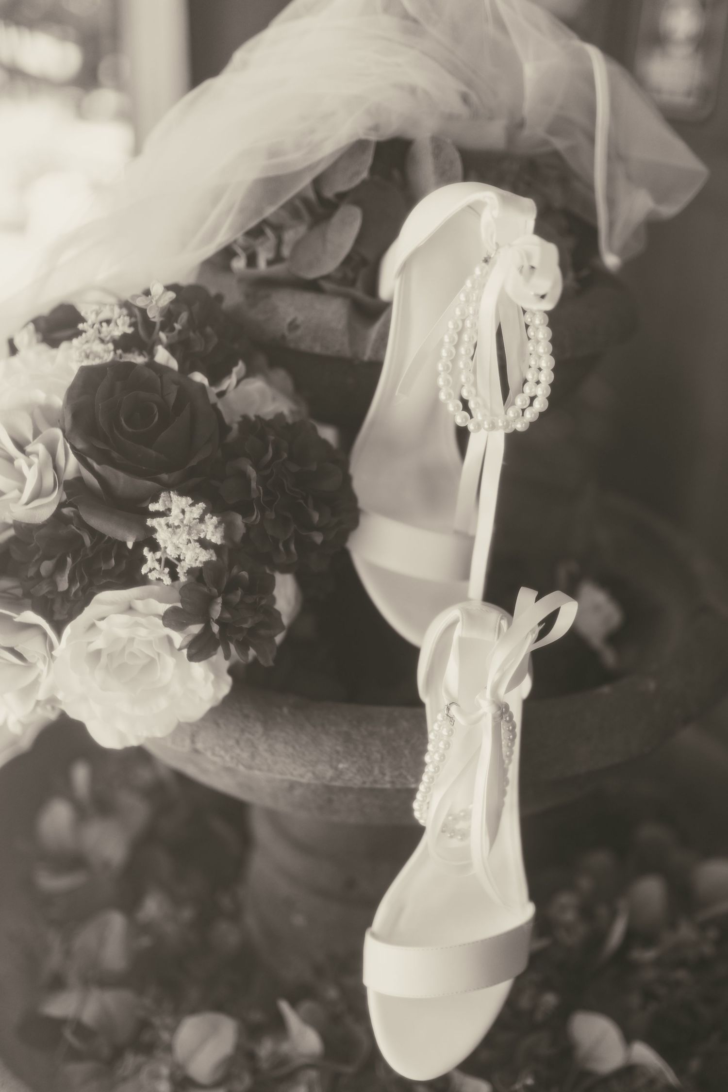 Black and white grainy film photo of bride shoes in Wooster Ohio by Gypsy Lens Photography. Moody, vintage, documentary wedding photography.