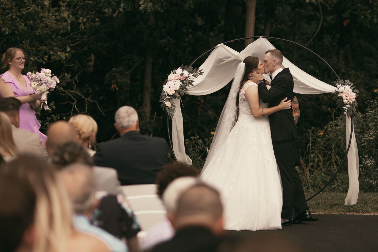 Bride and groom first kiss at ceremony in Cleveland Ohio by Gypsy Lens Photography. Moody, vintage, documentary wedding photographer.