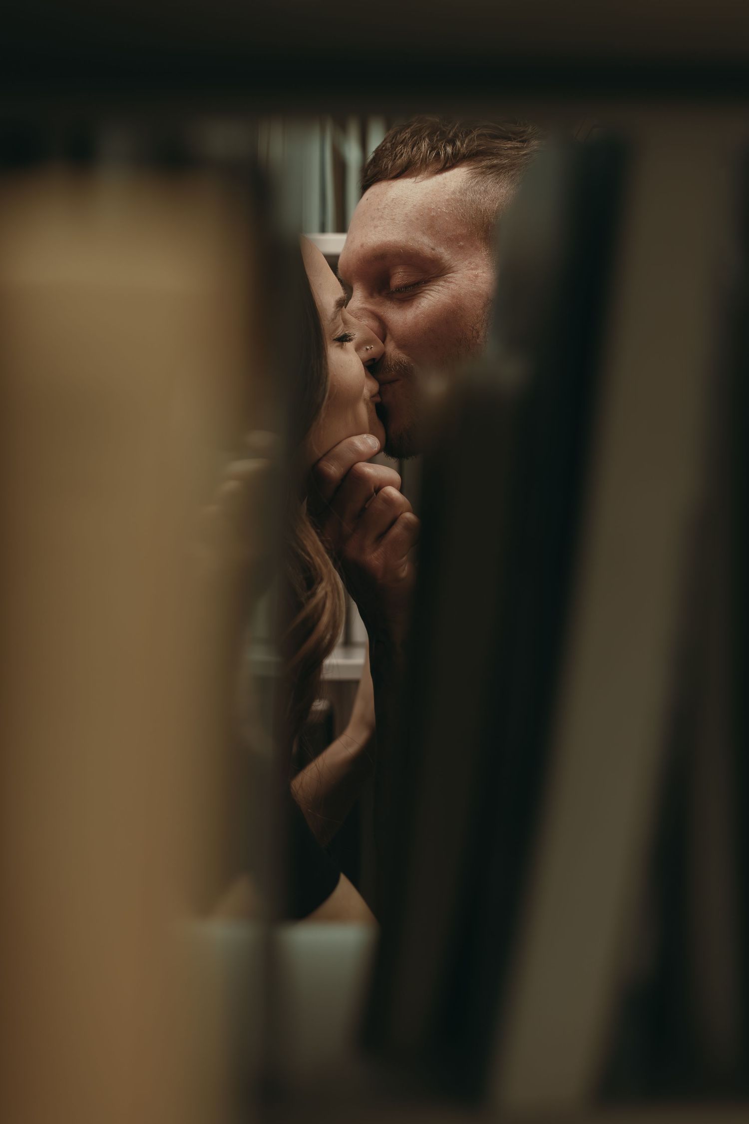 Engaged couple kissing at library in Cleveland Ohio by Gypsy Lens Photography. Moody, filmy, vintage, documentary wedding photography