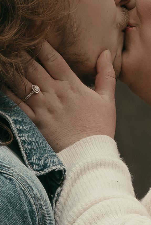 Close up kiss and ring of couple in Lake County Ohio by Gypsy Lens Photography. Moody, filmy, vintage, documentary wedding photography