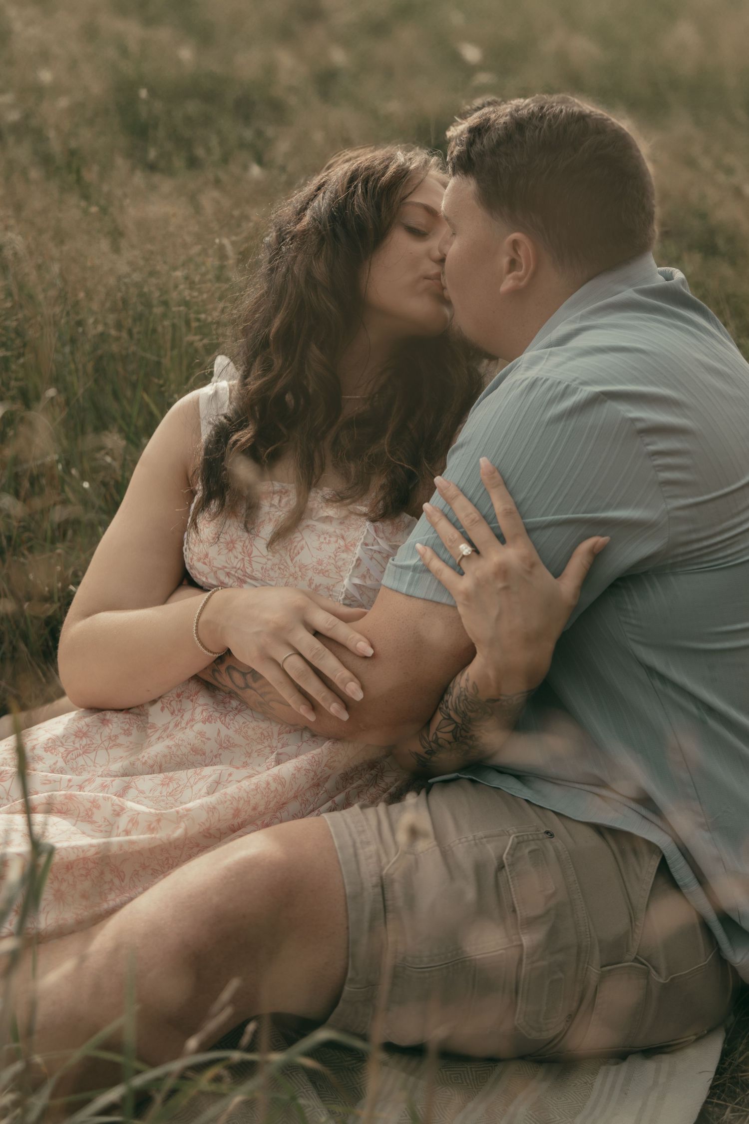 Engaged couple in wildflower meadow in Lake County Ohio by Gypsy Lens Photography. Moody, filmy, vintage, documentary wedding photography